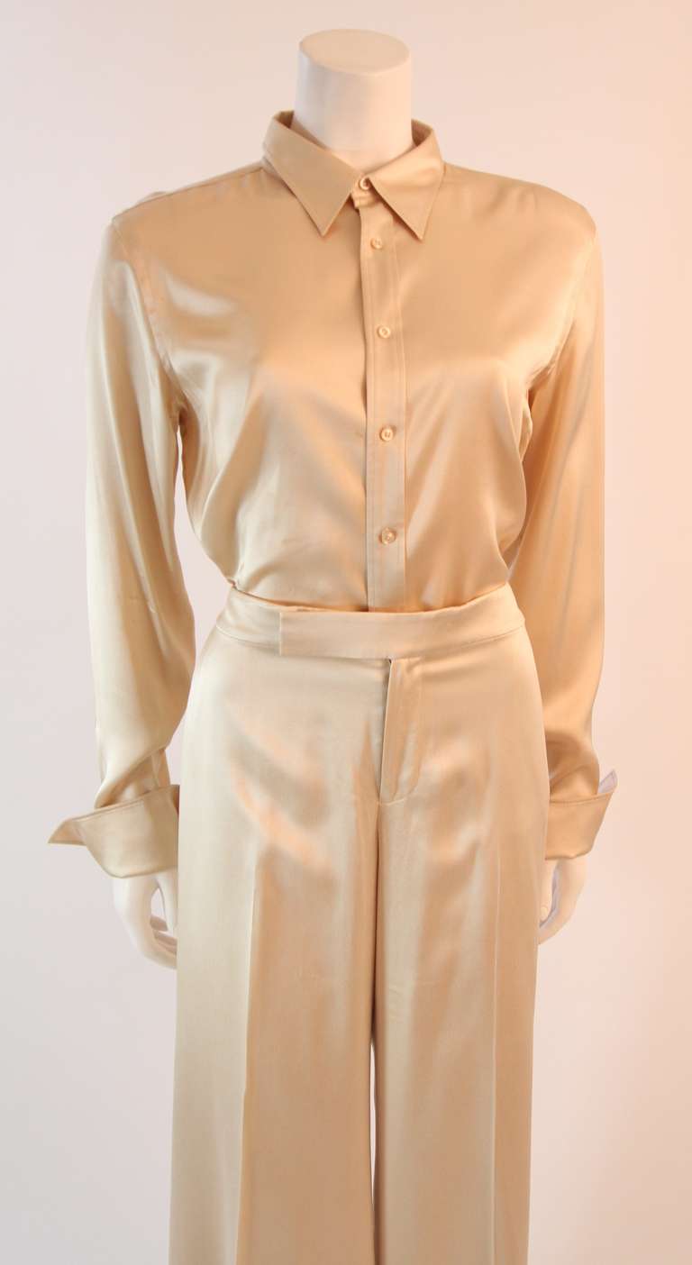 This is a chic Ralph Lauren Black Label set. The set is a creamy hue of champagne Ivory. The pants have a fantastic wide cut. The shirt features a classic button up design and light weight stretch silk composition. An effortlessly simple, chic, and