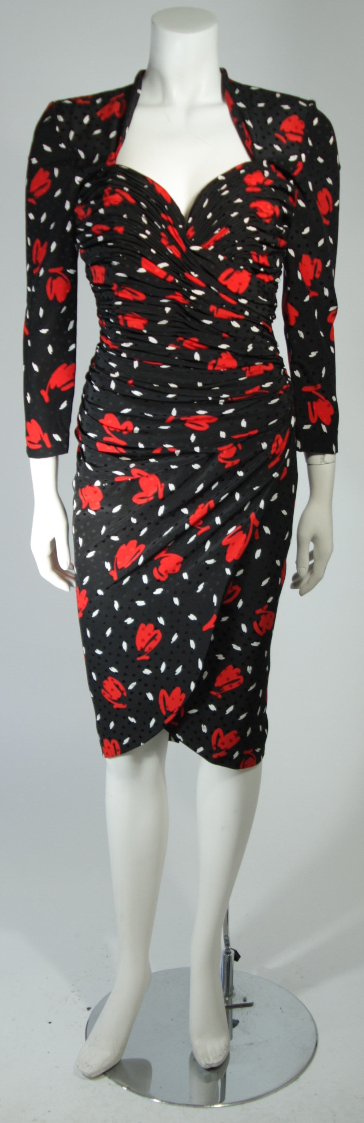 This vintage cocktail dress is fashioned from a black and white polka dot dress featuring an abstract rose and/or heart print. There is ruching throughout and and a center back zipper. In excellent condition

**Please cross-reference measurements