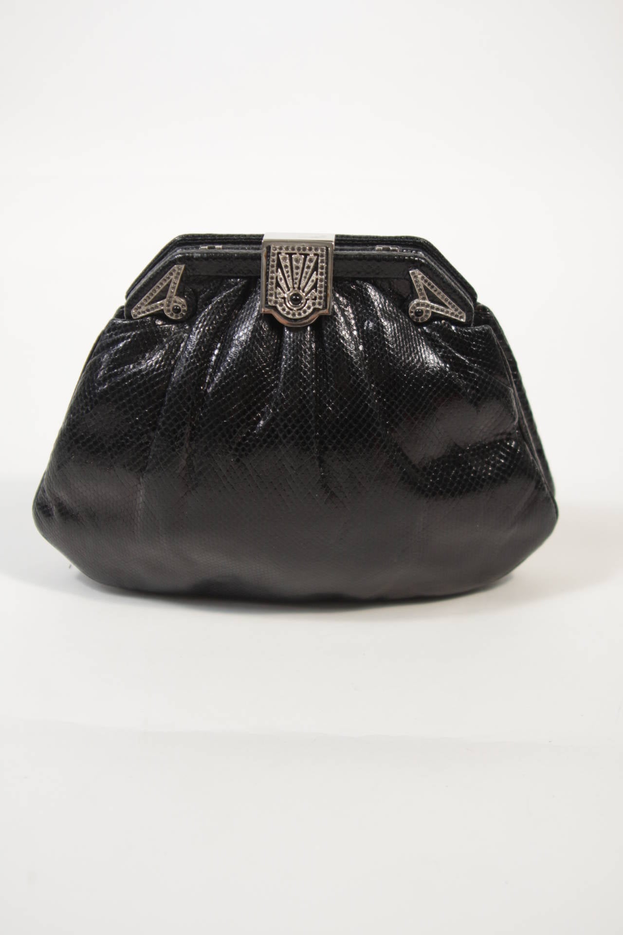 This vintage Judith Leiber handbag is composed of black lizard. The clasp closure is rhinestone encrusted. In excellent condition, sold 'as is'. Comes with original comb and dust bag. 

**Please cross-reference measurements for personal