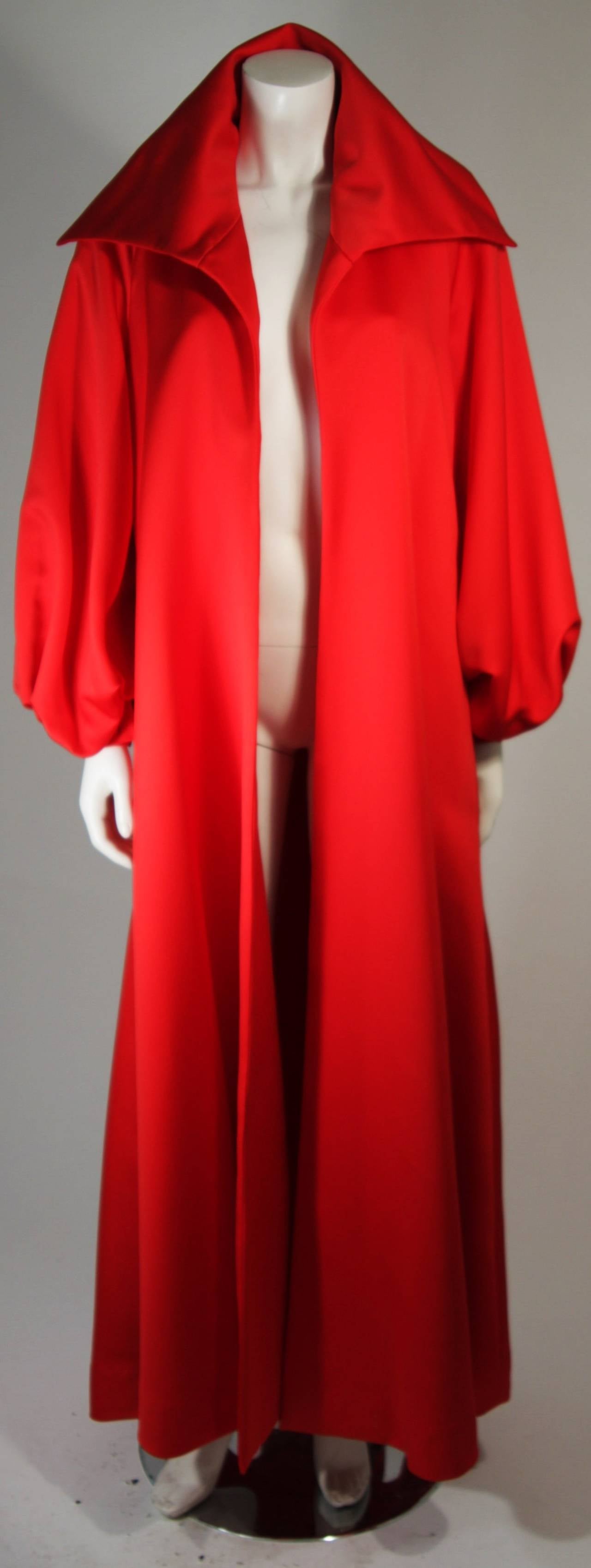 This Victor Costa design is available for viewing at our Beverly Hills Boutique. We offer a large selection of evening gowns and luxury garments.

This coat is composed of a rich red satin which is accented by a dramatic collar and sleeve design.