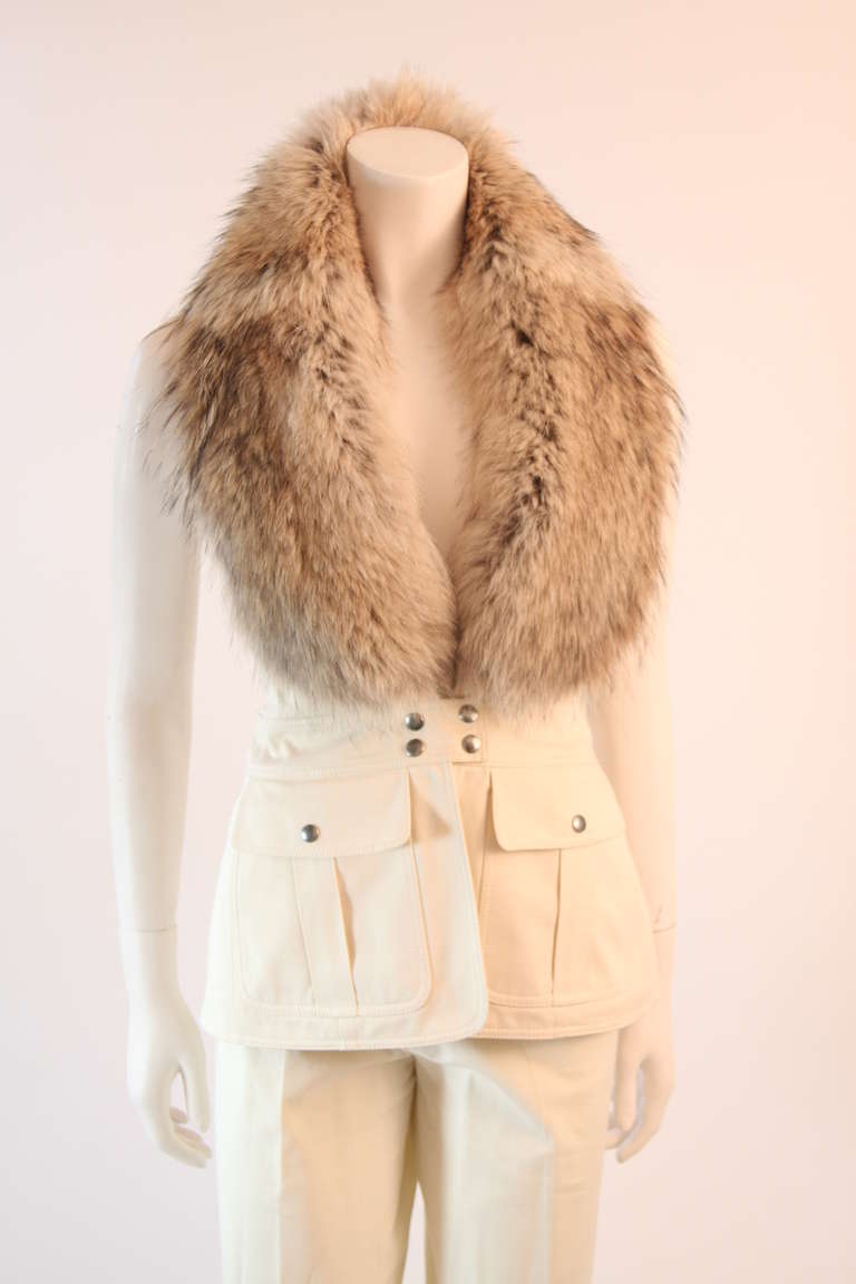 This is a beautiful Michael Kors two piece Safari inspired set. The halter vest features a snap front closure, two utility style pockets, and a removable satin backed coyote fur collar. The pants are a classic trouser fit. The set is composed of a