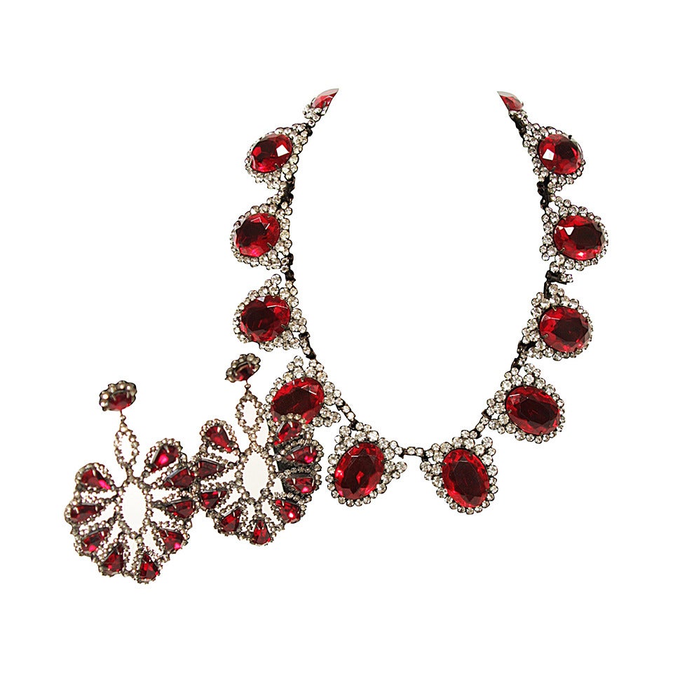 Drench yourself in opulence with this showstopper from Kenneth Jay Lane. 
Rich red jewels are one inch by three-quarters of an inch surrounded by clear sparkling rhinestones. 
Length 17 inches
Marked K.J.L.
Earrings have pear shaped red jewels