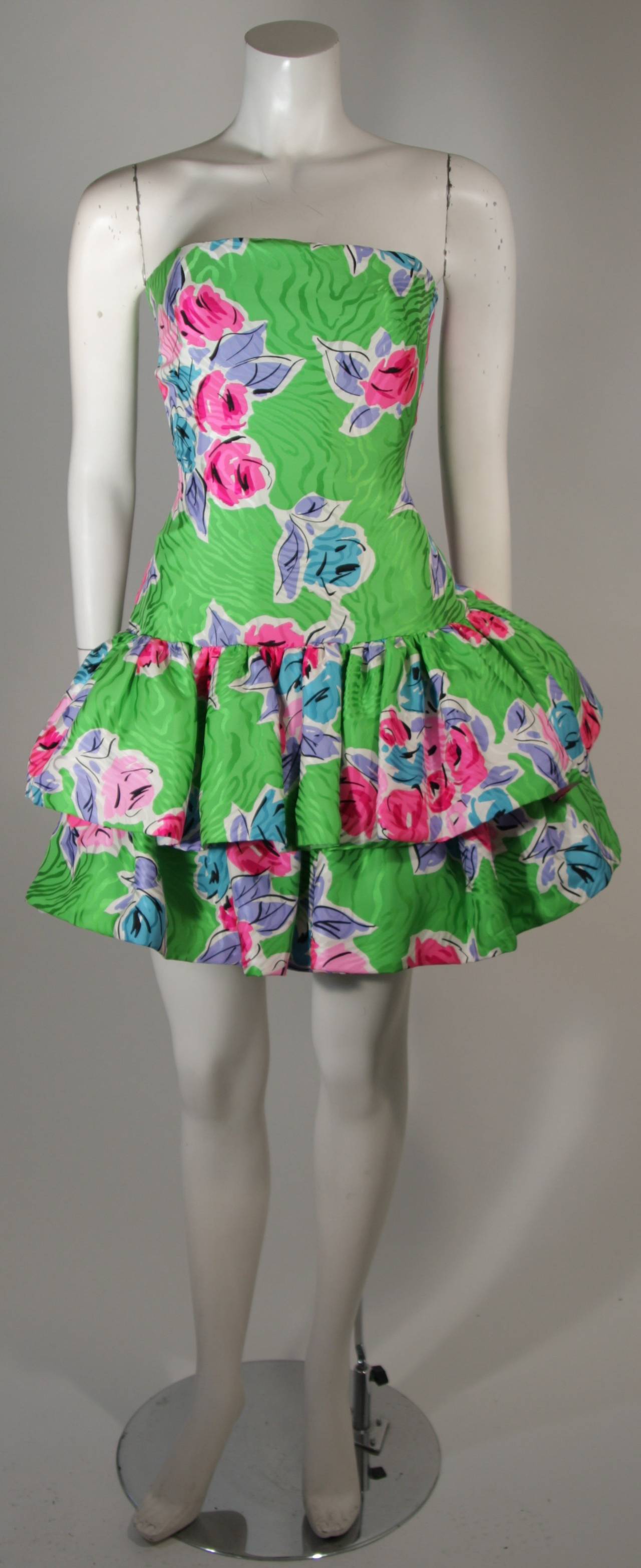 This Scaasi ensemble is composed of a textured silk in green with a floral pattern/design. The dress features a zipper closure. This has a lot of volume, a wonderful design. Made in U.S.A. 

**Please cross-reference measurements for personal