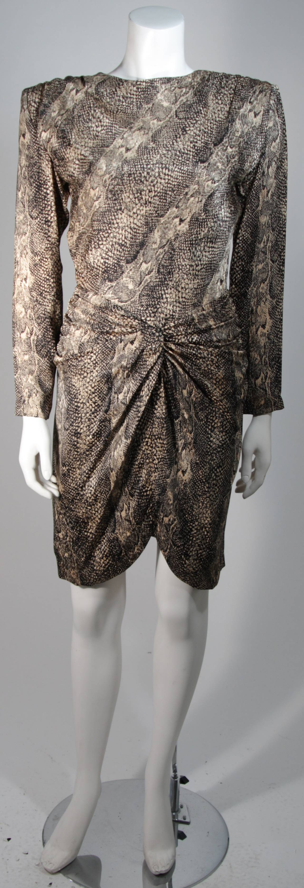 This Vicky Tiel dress is composed of a brown and black silk with snakeskin print. There is draping at the hip and a center back zipper closure. In excellent condition. Made in France.

This item is from the personal estate of Shirlee