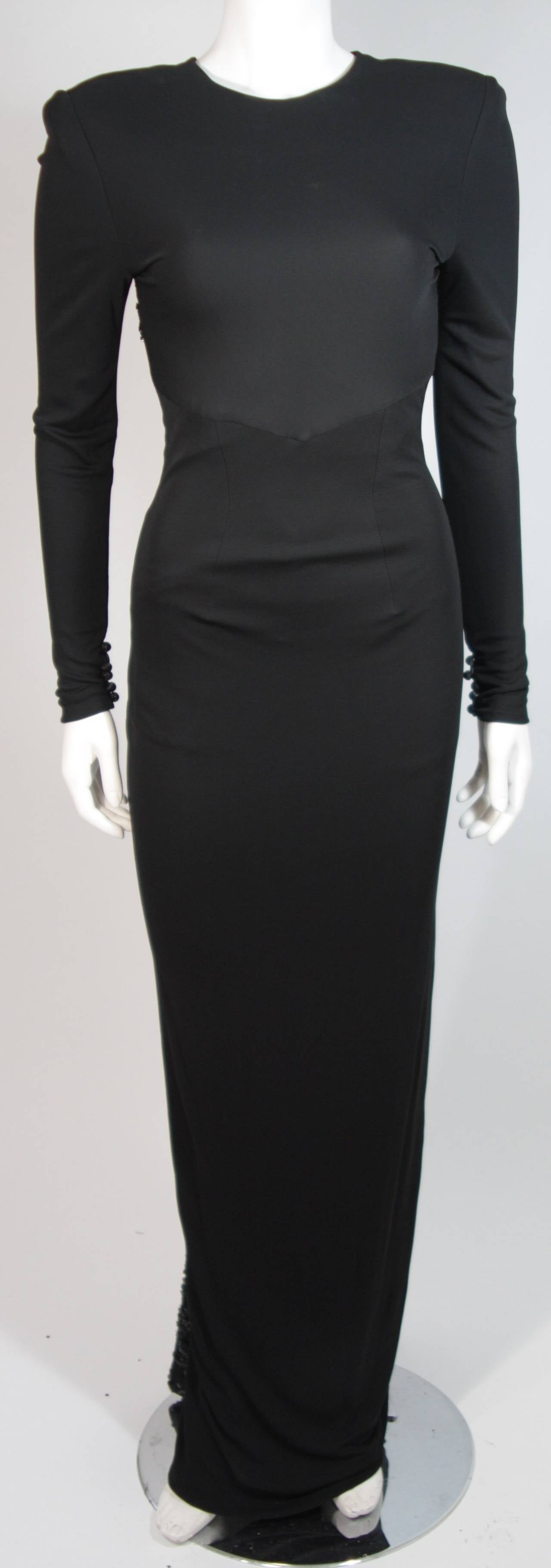 This Vicky Tiel gown is composed of a black jersey and features sequin lace accents.  There are padded shoulders. There is a center back zipper closure for ease of access. In excellent condition. Made in France.

This item is from the personal