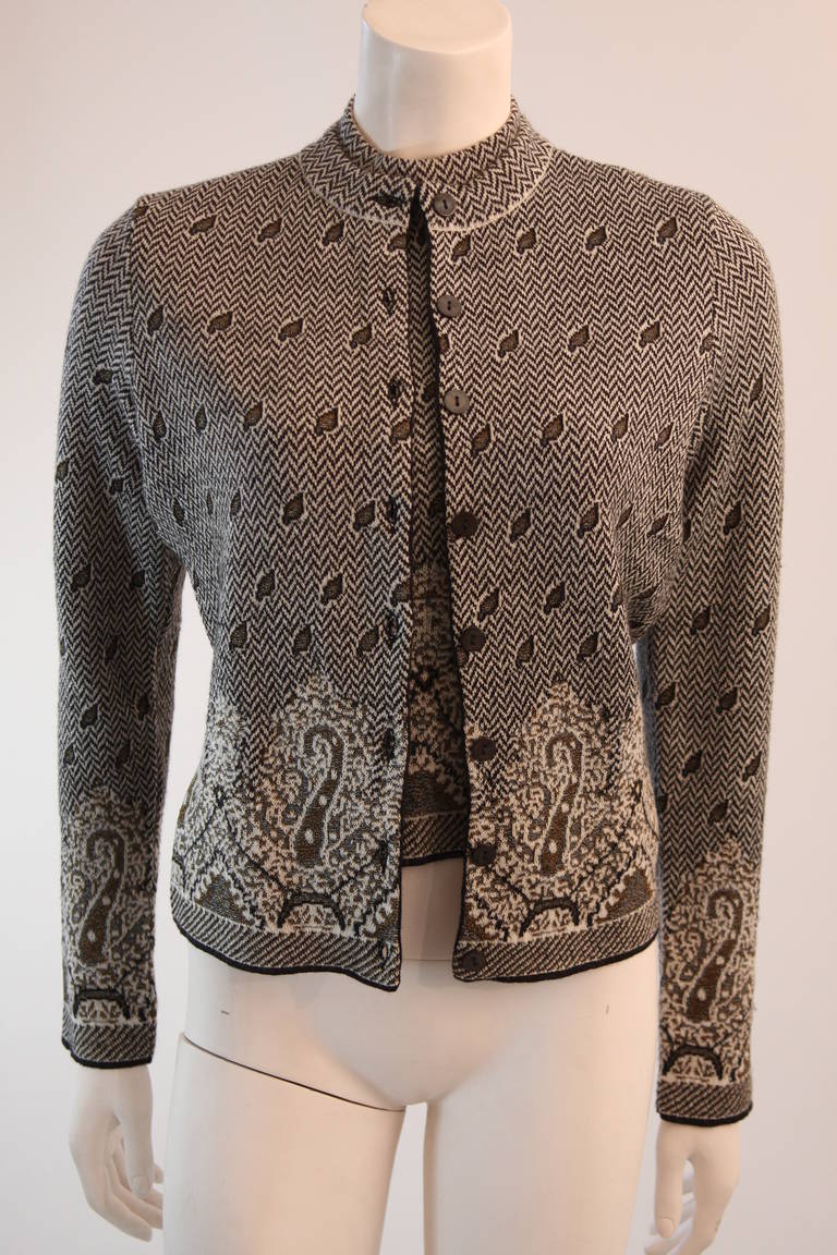 This is a kenzo cardigan set. This set features a long sleeve button up cardigan and a short sleeve mock neck top. The fabric is composed from a supple wool blend with the perfect amount of stretch. Made in France. 

Measures