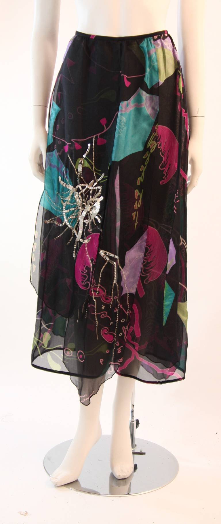 These are a wonderful pair of Christian Lacroix pants. They are composed of a flowing tropical print silk chiffon. The pants feature an overlay with sequin embellishment and zipper closure for ease of access. These are a wonderfully light weight and