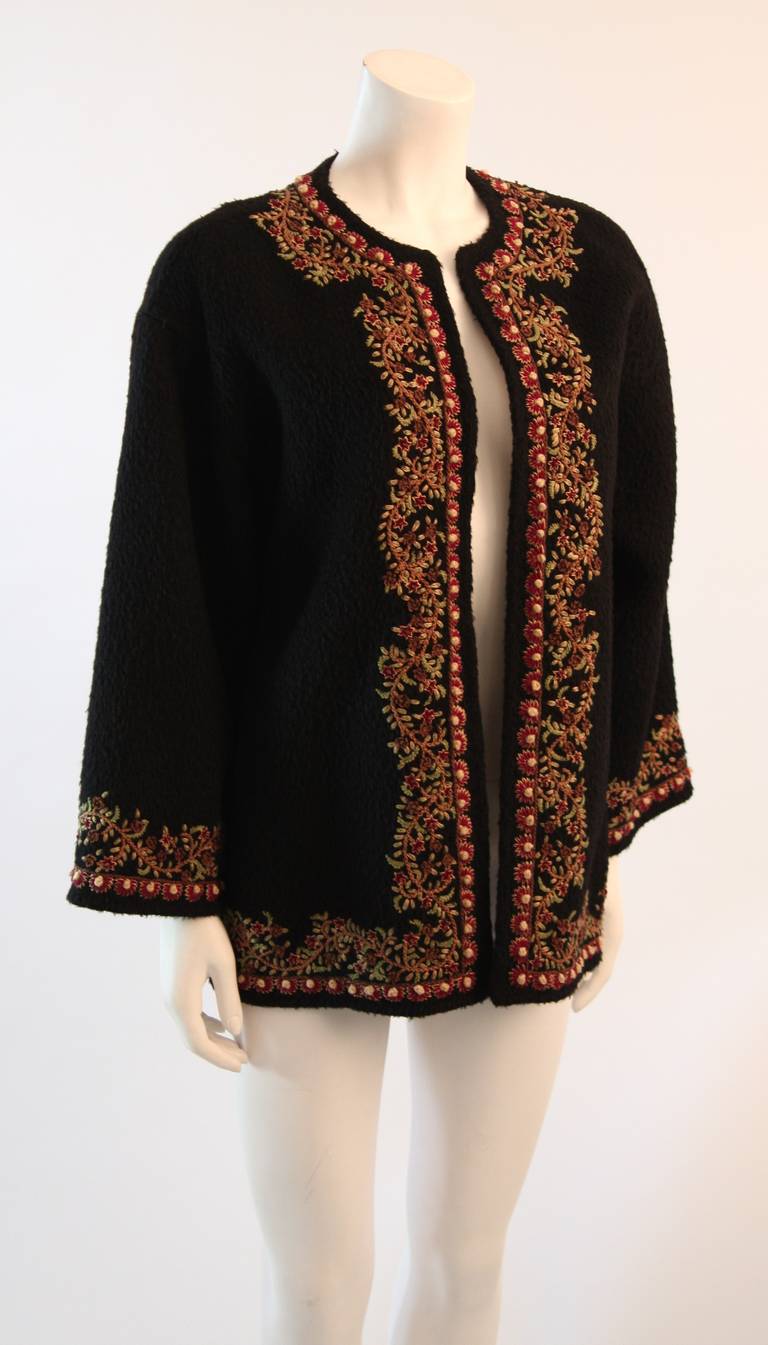 This is a great Oscar De La Renta sweater. This sweater is composed of a wonderful wool alpaca blend in a beautiful rich black. Embroidered with a floral motif in classic autumn hues. Perfect and supple warmth. Made in Russia. 

Measures