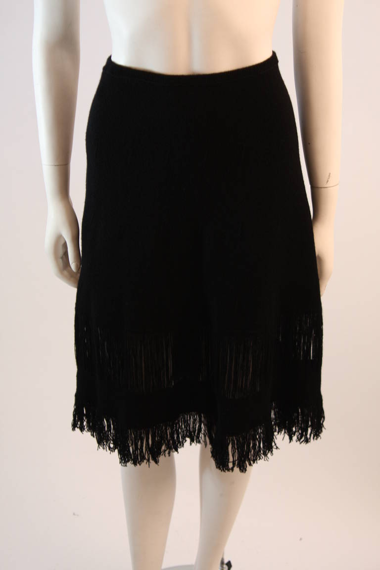 This is a beautiful Gucci skirt. It is composed of a wonderful extra supple cashmere. This A-Line skirt is a wonderful black knit featuring a fringe trim and sheer detail. Made in Italy. Original tags.

Measures (Approximately)
Size M
Length: