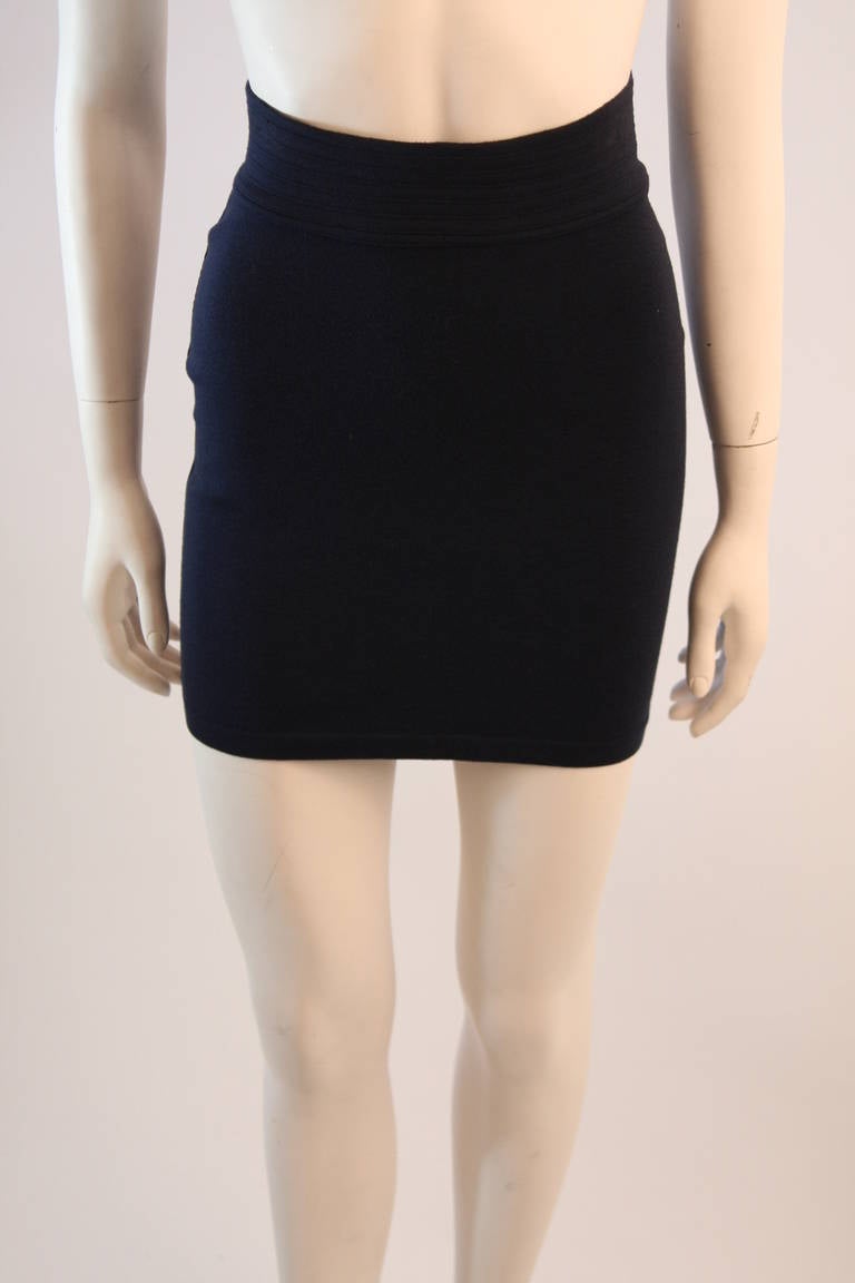 This is an Alaia original. The skirt is in true fashion, a classic Alaia design. It is composed of a high stretch knit in a navy hue. Perfect design. Made in France.

Measures (Approximately)
Size M
Length: 16