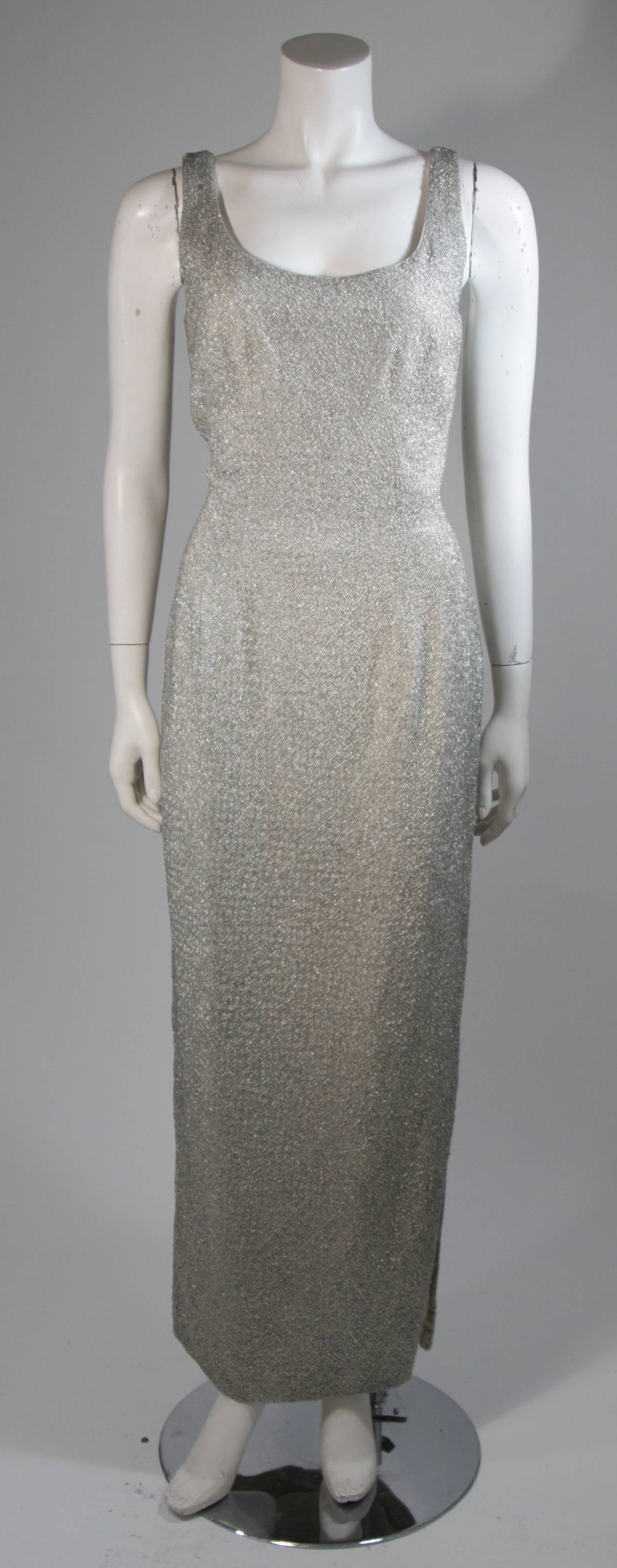 This Haute Couture International 1960s gown is an absolute stunner featuring immaculate beading throughout in a silver hue. There is a center back zipper closure. It is composed of 100% silk. In excellent condition. Made in Hong Kong. 

**Please