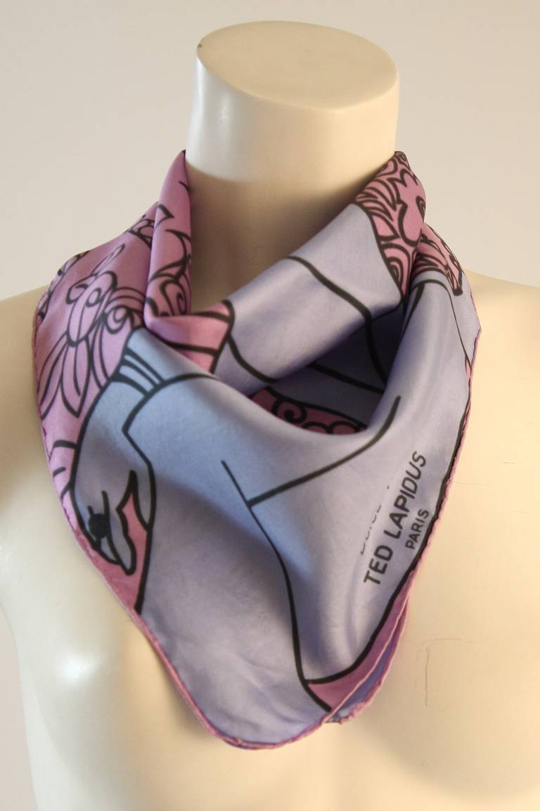This is a fantastic Ted Lapidus scarf. In a wonderful hue of periwinkle and lavender this scarf features a whimsical illustration of a belle in 