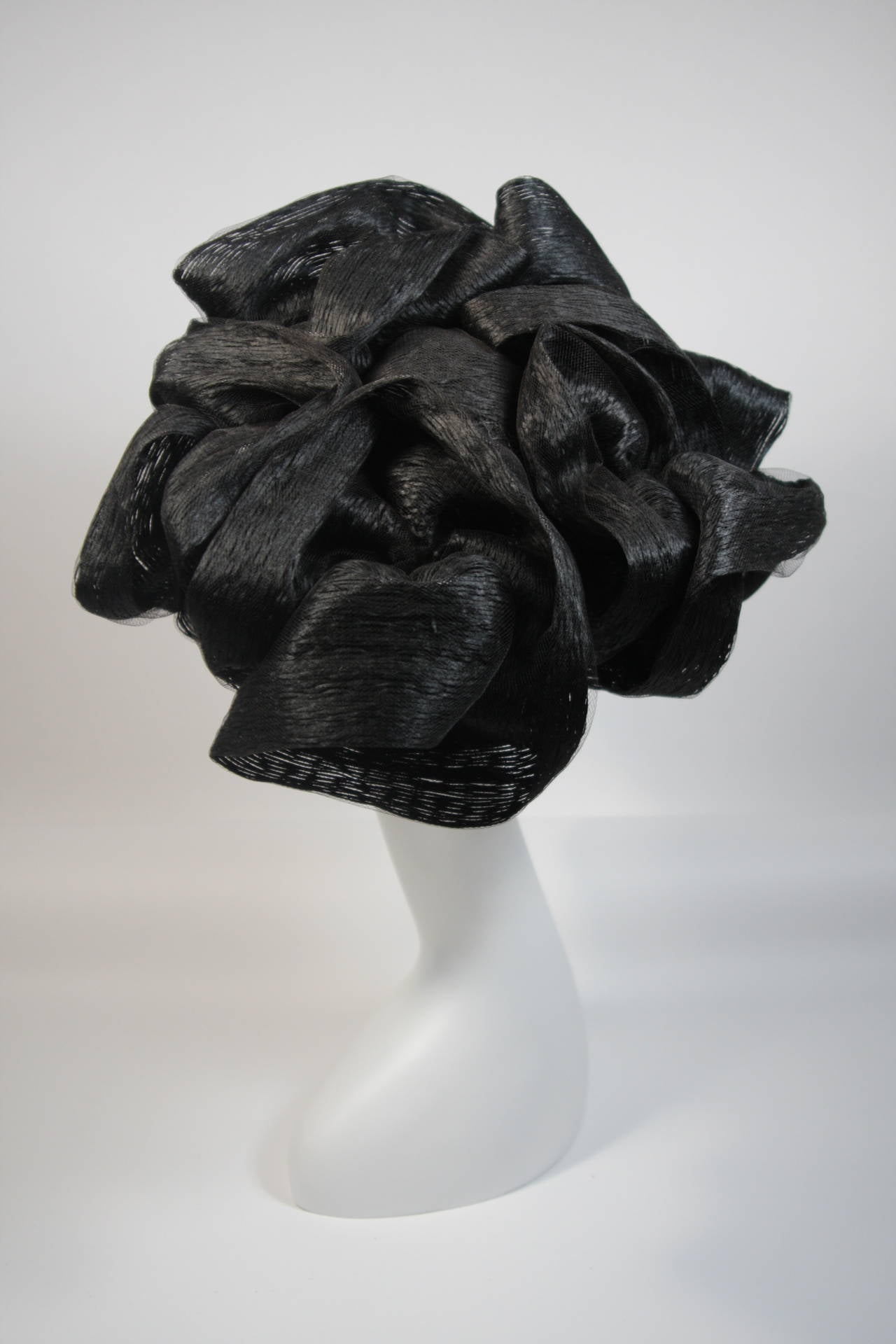 This Maria Pia hat is composed of a black ribbon in net, designed with dimension. In excellent condition, the interior fabric of the hat has slight discoloration and fading (see photos). Made in Italy.

**Please cross-reference measurements for