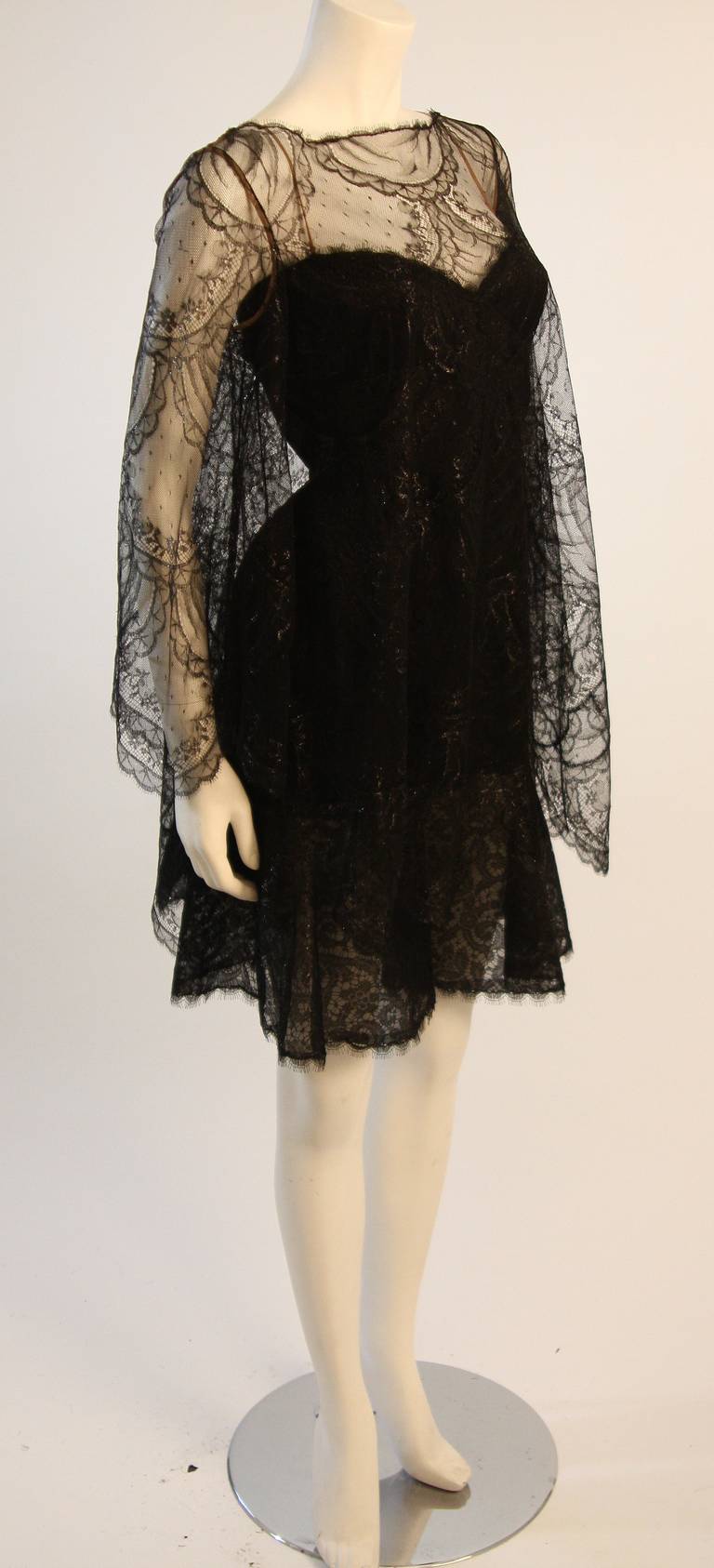 This is a stunning Bill Blass cocktail dress. The dress features a wonderful Chantilly lace blouse overlay. The lace has a metallic and reflective quality. This is a very beautiful combination, the dress has a wonderful fitted and flared silhouette.