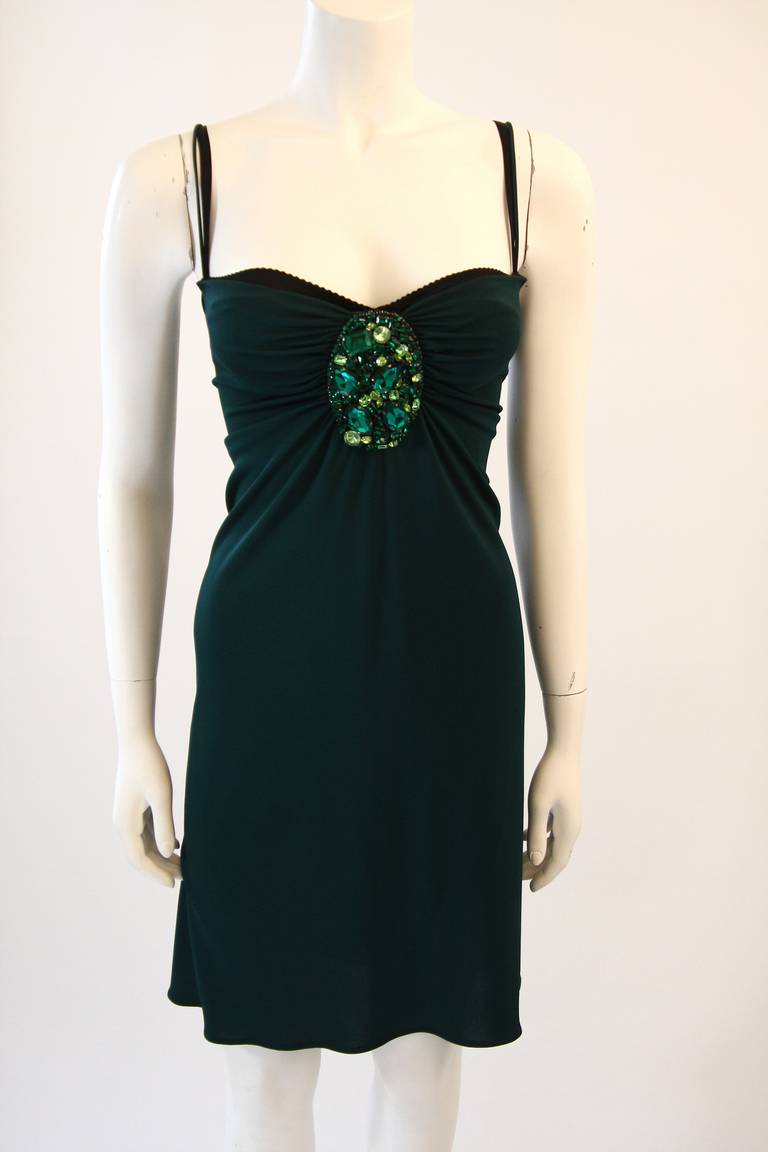 This is a brilliant Dolce and Gabbana dress. It is composed of an amazing stretch jersey in a deep green hue. The dress features an attached bra for the classic Dolce and Gabbana style. There is a center back zipper for ease of access. Made in
