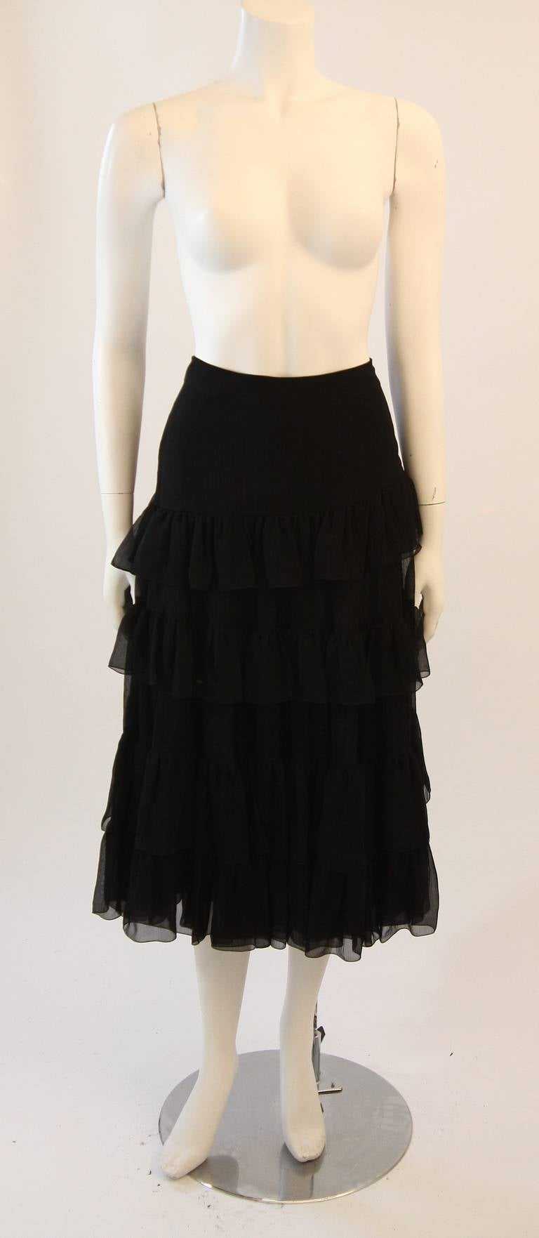 This is a brilliant Prada skirt. This skirt features two pieces, a stretch silk slip and crepe silk outer. There is a side zipper for ease of access. Great piece and easy to style from day to night. Made in Italy. 

Measures (Approximately)
Size