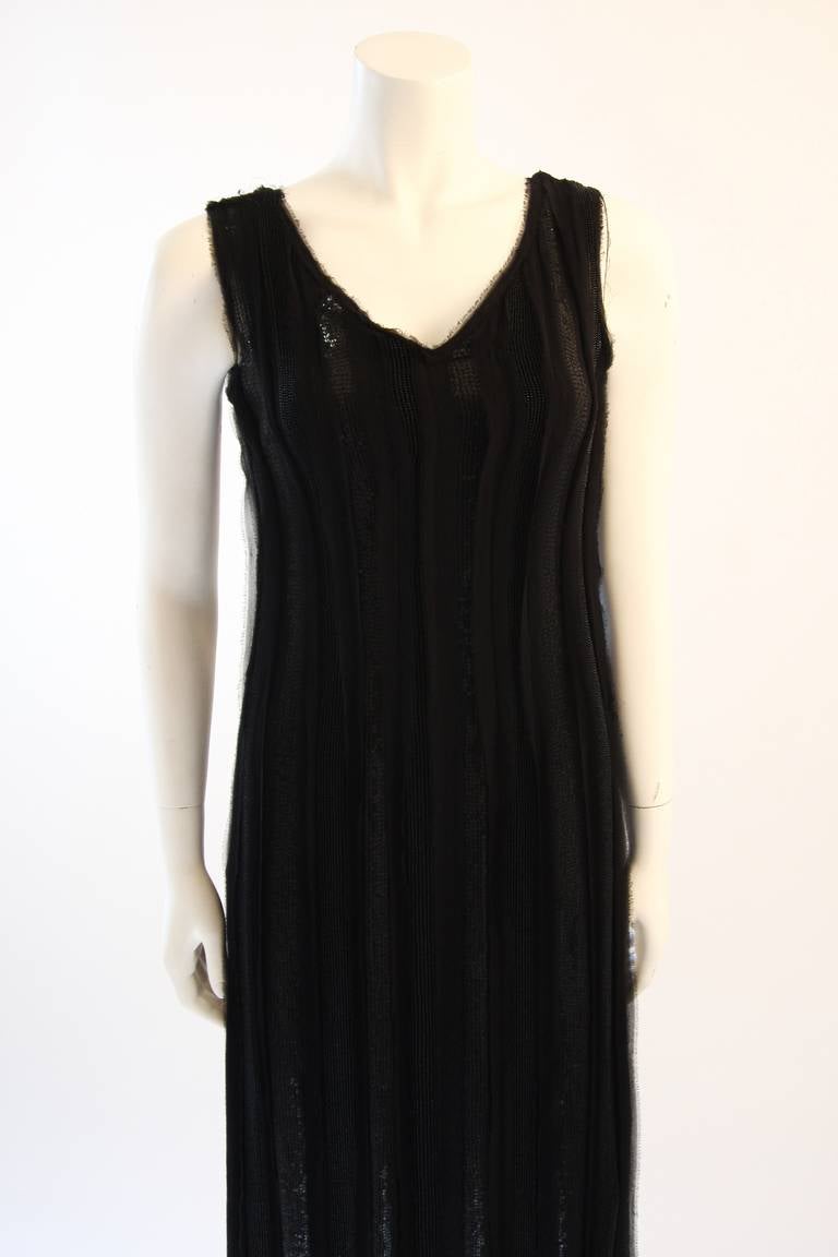 This is an Alberta Ferretti design. The dress is a full length and is composed of a fine silk with raw edges. It features black beading and embellishment. There is a v-neck and back. Side zipper closure for ease of access. 

Measures