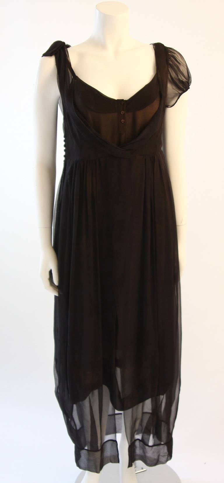 This is a chic Zac Posen ensemble. This two piece set can be worn together or styled individually as a dress and, or top. It has a raw and Steam Punk inspired design. The thin silk chiffon has an off black hue with a faded and discolored effect (Off