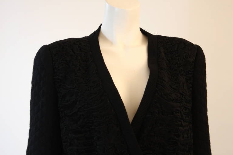 This is a Valentino design. This cardigan style jacket features front Broadtail panels and a quilted knit. The jacket is silk lined and double breast style. Made in Italy. 

Measures (Approximately)
Length: 28.5