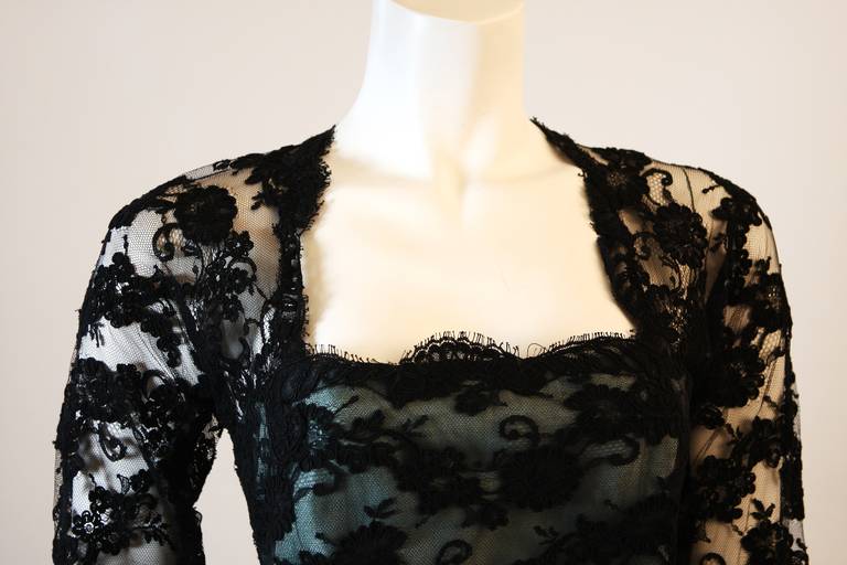 This is an Oscar De La Renta gown. This beautiful gown features an exquisite black lace overlay, and aqua skirt with horse hair hem for added flare (please note item condition: The aqua is discolored and faded in certain areas, this is reflected in