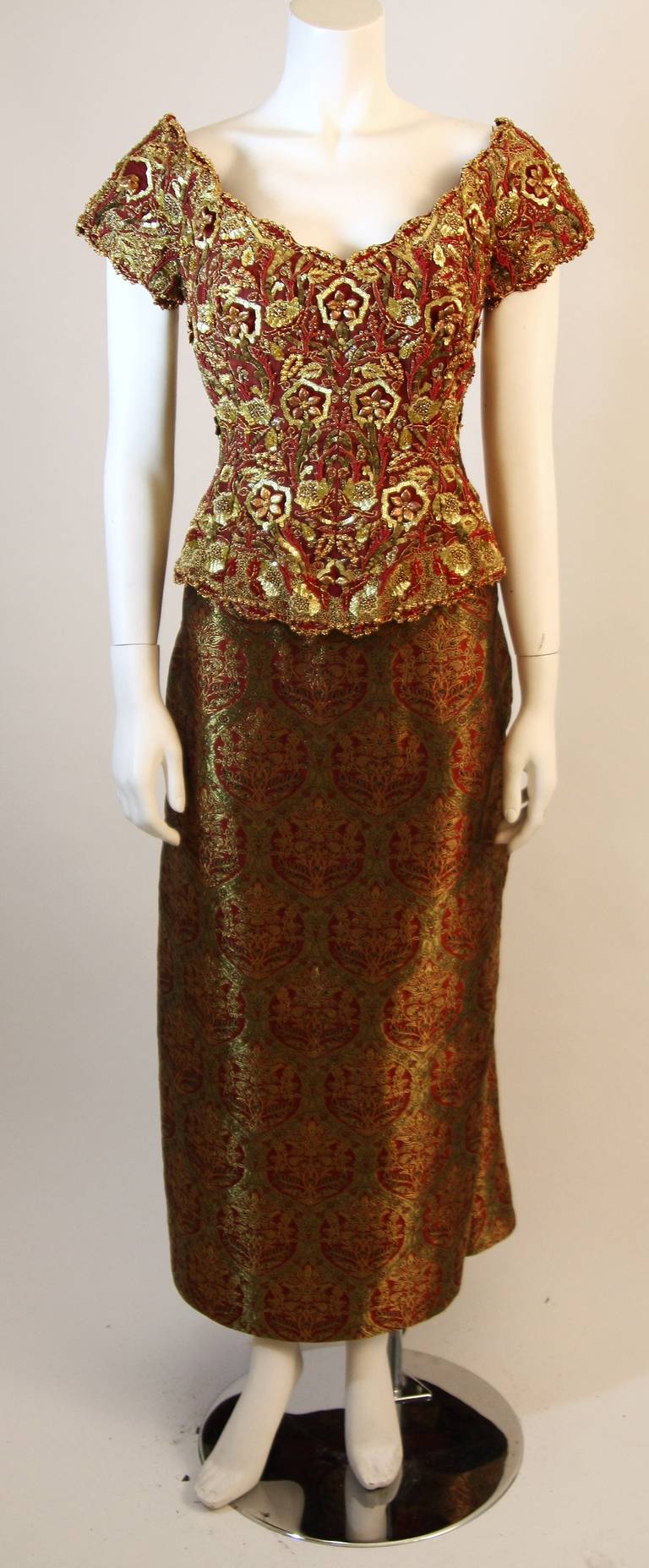 This is a beautiful Oscar De La Renta ensemble. This wonderful set features a strikingly embellished beaded and embroidered bodice with center back zipper closure. The top can be used on or off the shoulders. The beautiful silk skirt features a