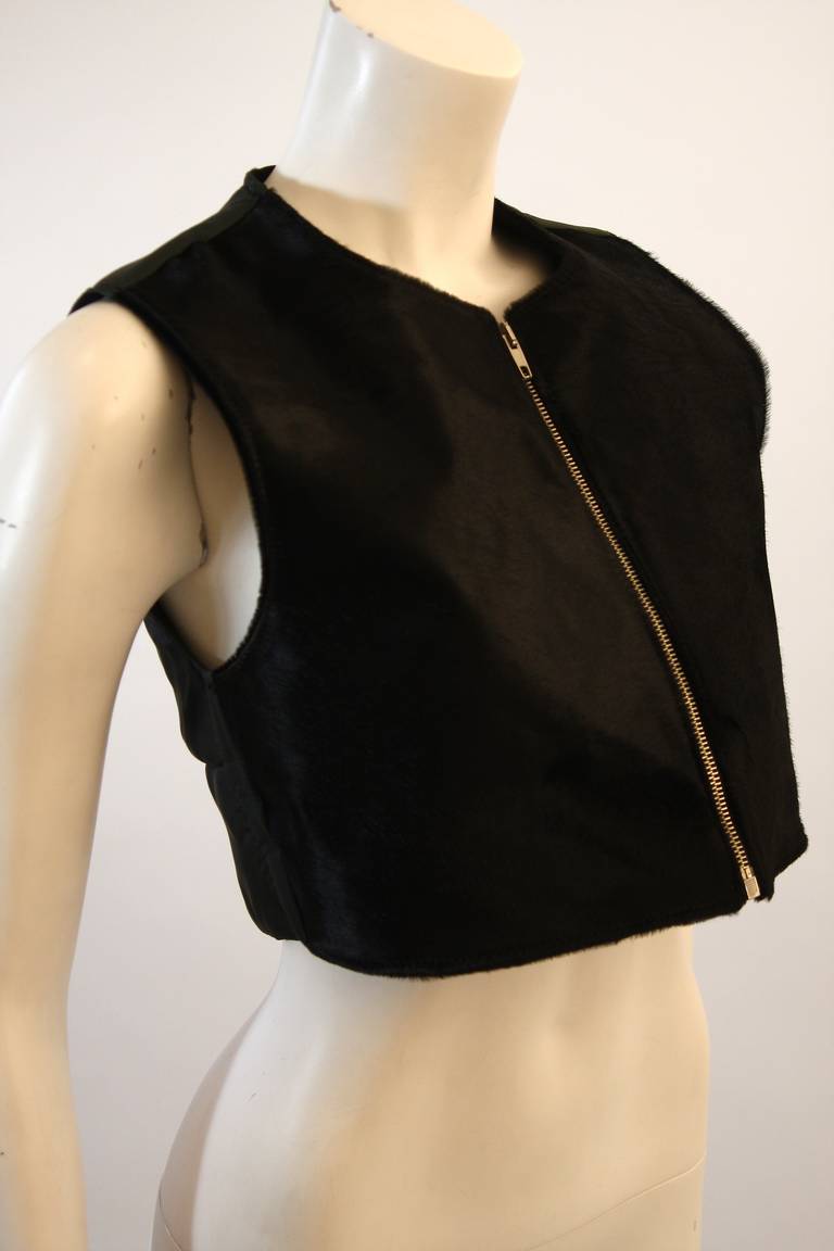 This is a Helmut Lang design. This vest features a cowhide front with a quilted detailed back and a center front zipper. Made in Italy. 

Measures ( Approximately)
Size 42
Length: 15.5