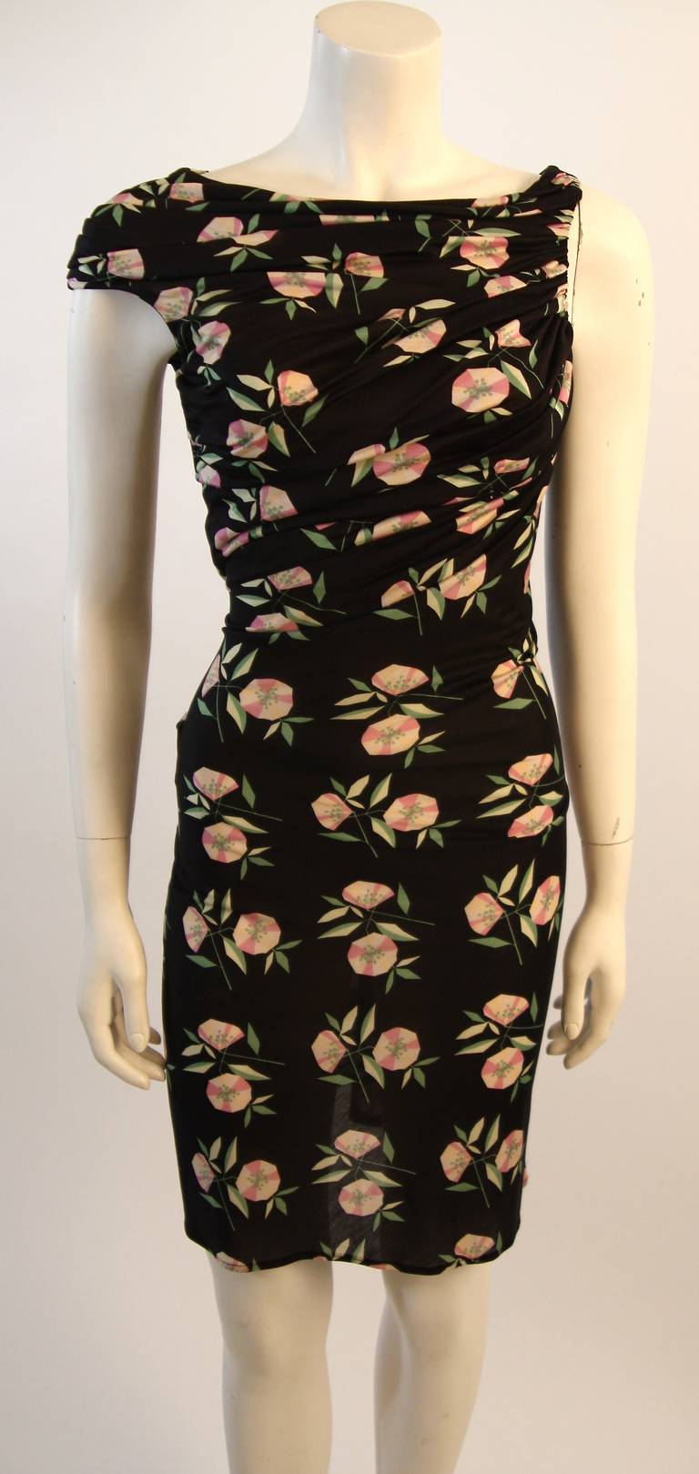 This is a great vintage piece by Gianni Versace Couture. It is composed of a semi-sheer lined silk jersey blend floral print fabric. The dress is beautifully draped and ruched. There is an inside body suit with crotch fastening. Made in Italy.
