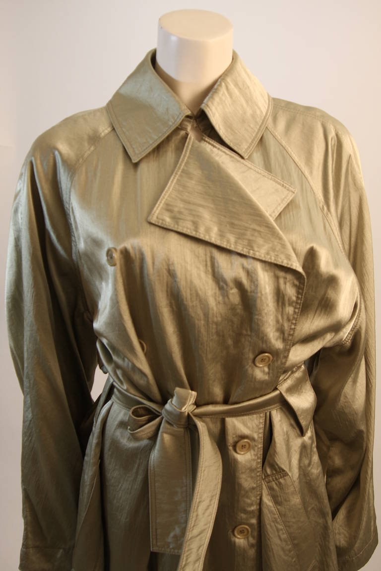 This is a gorgeous Alaia coat. This trench style coat is composed of silky yet strong sage hued fabric. The coat features a large collar and belt. Can be used as a coat or a dress, very chic design. 

Measures (Approximately)
Length: 54