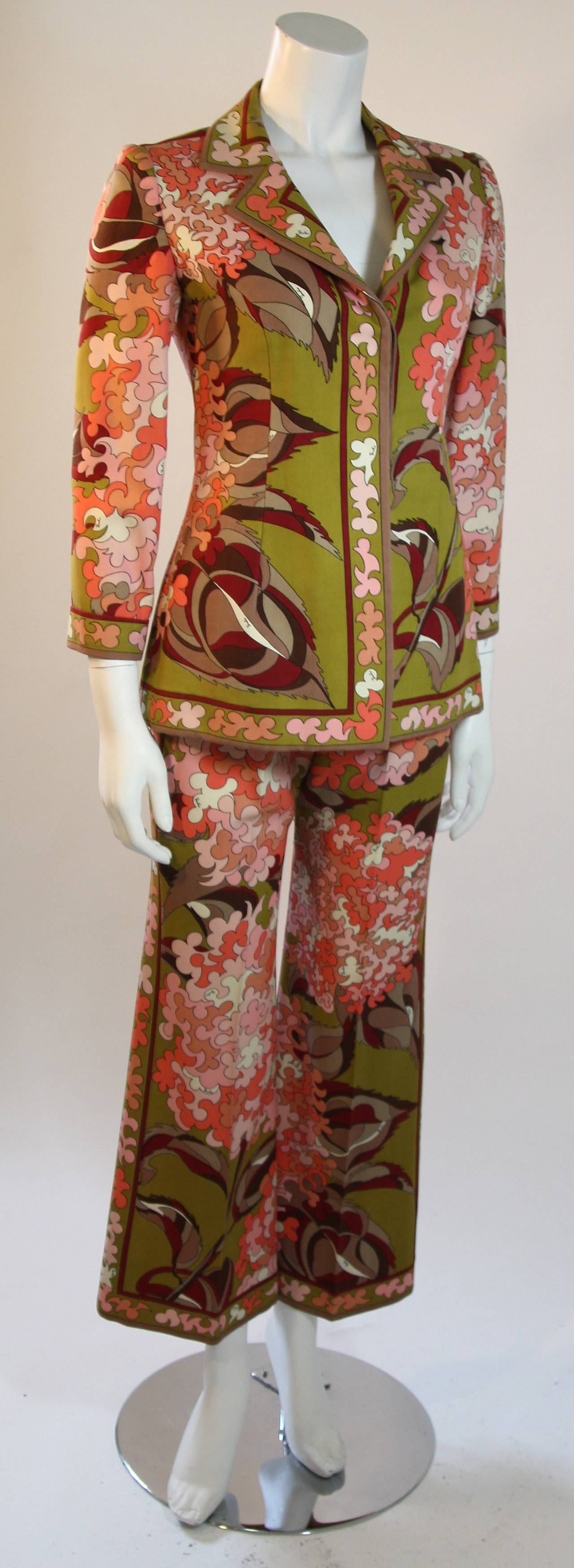 This is an Emilio Pucci suit. The suit features a center front button closure jacket and flared pants with center back zipper closure. The jacket has a few wear marks (See photographs). Made it Italy. 

Measures (Approximately)
Jacket
Length: