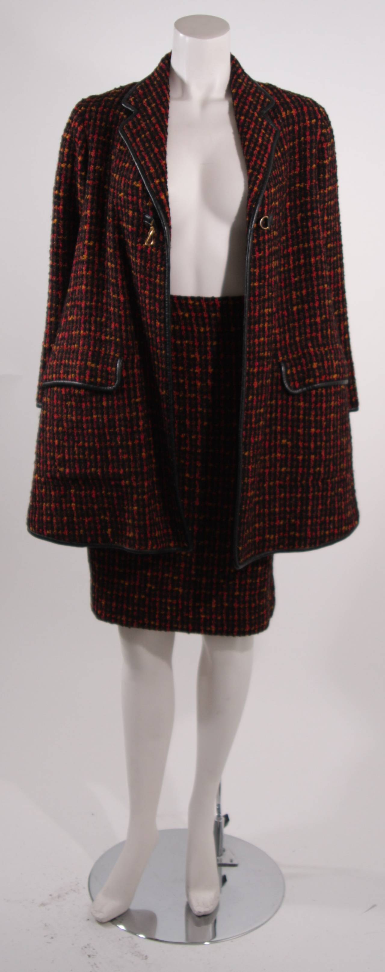 This a Bonnie Cashin design. This sharp two piece features an over-sized coat with two front pockets and gold hardware. The skirt a wonderful pencil silhouette with a zipper closure. Composed of a lovely multi-colored tweed featuring yellow, red,