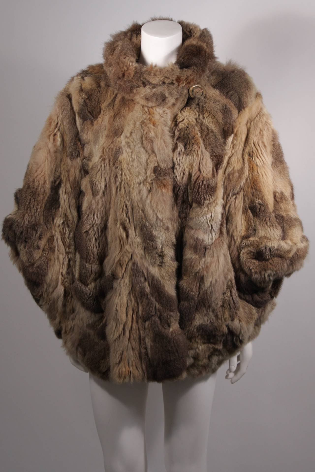 This is a Fendi Russian squirrel fur coat. This Fendi 365 fur jacket features a dolman style sleeve design. 
Fully lined in silk. There is a large metal button closure with 