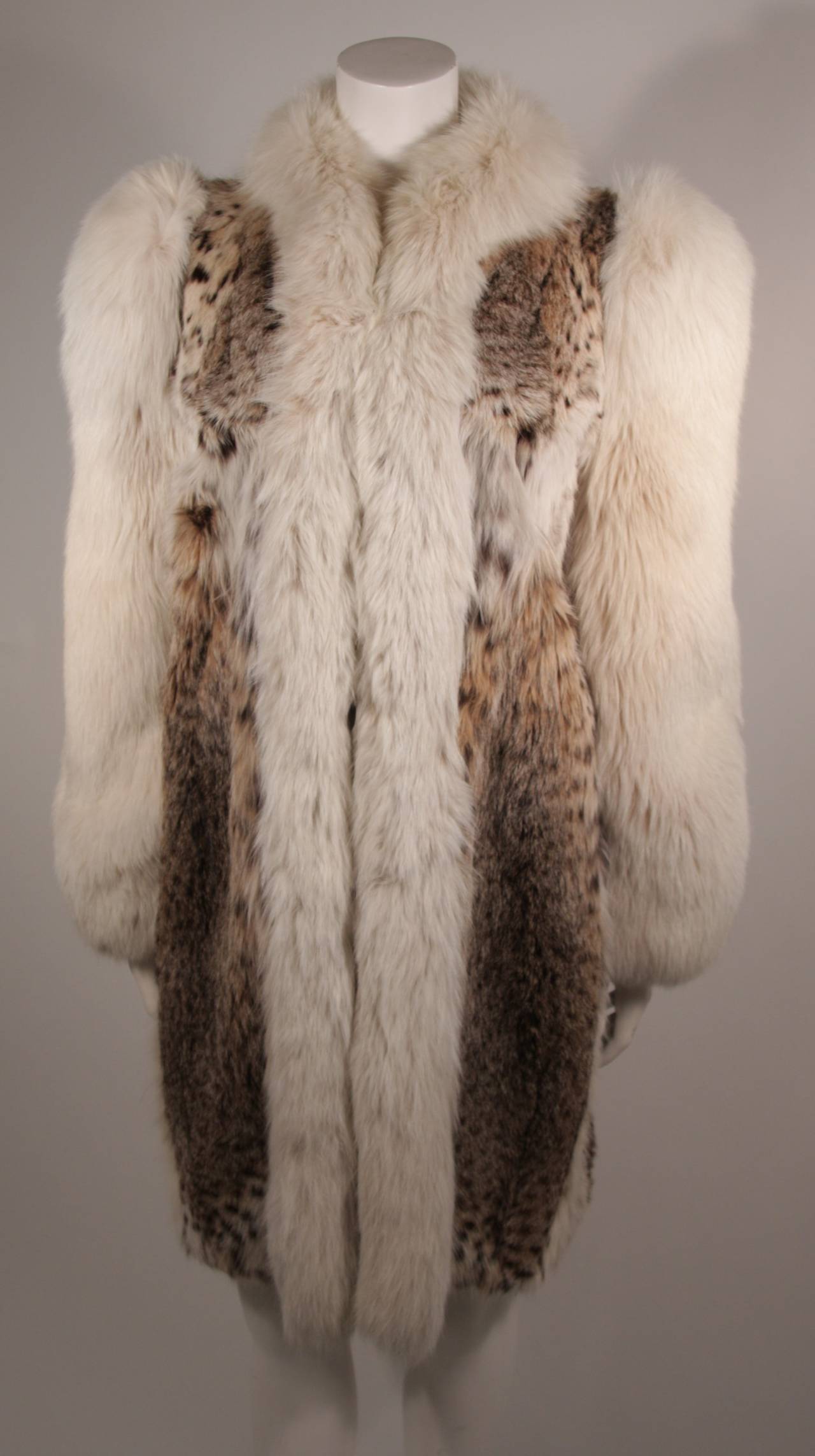 This is a Creeds of Toronto Lynx coat. This stunning coat is composed of Lynx and accented with fox. There are two side pockets. The coat is in good vintage condition, there is some slight wear at the cuffs, lining is in great condition. It is