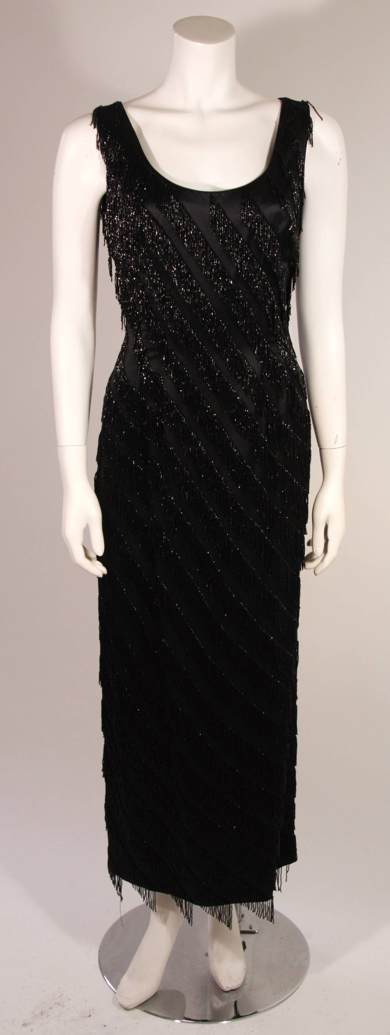 This is a striking Pauline Sheh design. The gown is composed of a black silk featuring a heavily beaded fringe design. There is a center back zipper closure for ease of access. Made in Hong Kong. 

Measures (Approximately)
Marked size 10 please