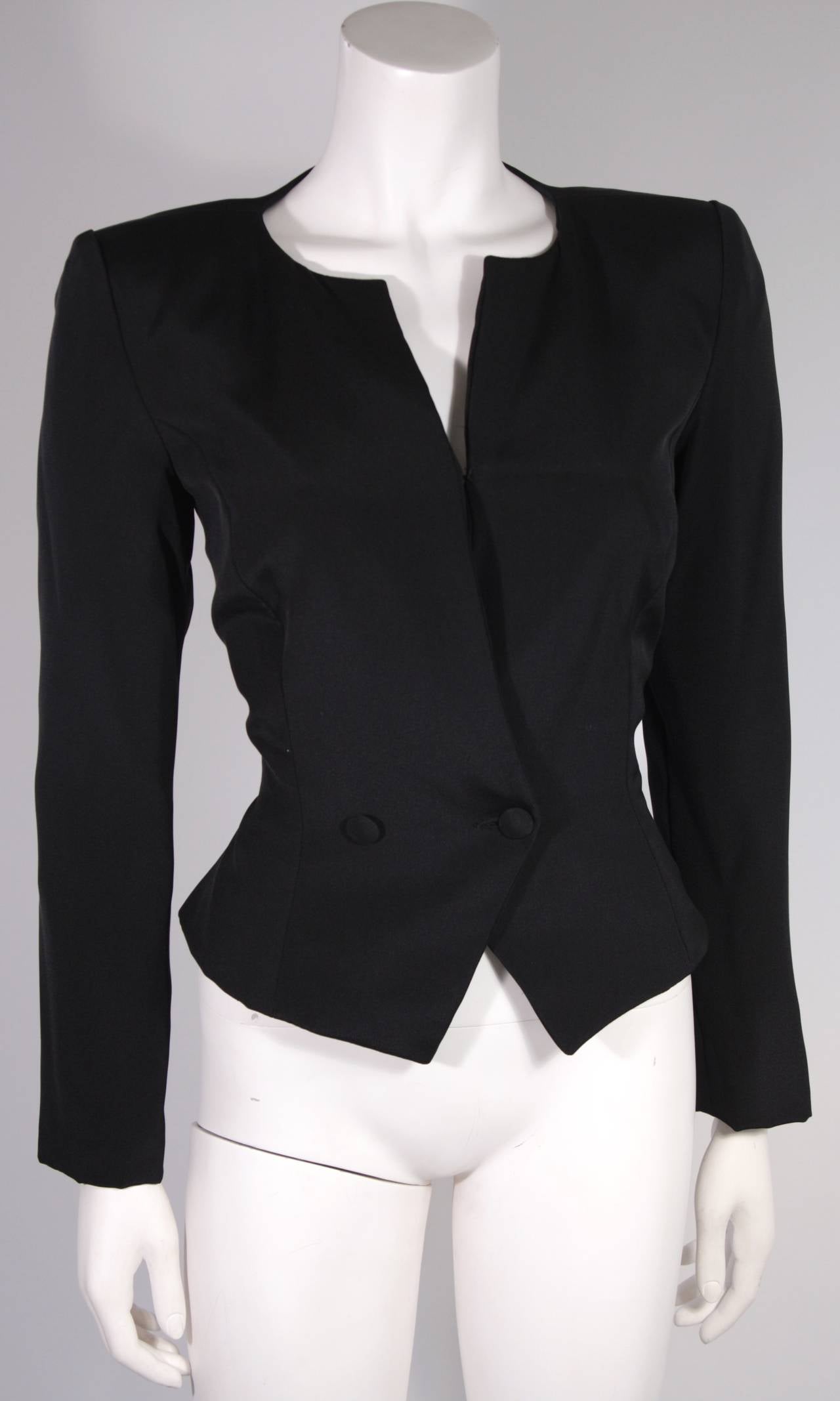 This is a Vicky Tiel design. A sophisticated yet sexy garment with a sheer lace back. The jacket features front button closures, as well as a hook and eye closure. Made in France. 

Measures (Approximately)

Length: 23