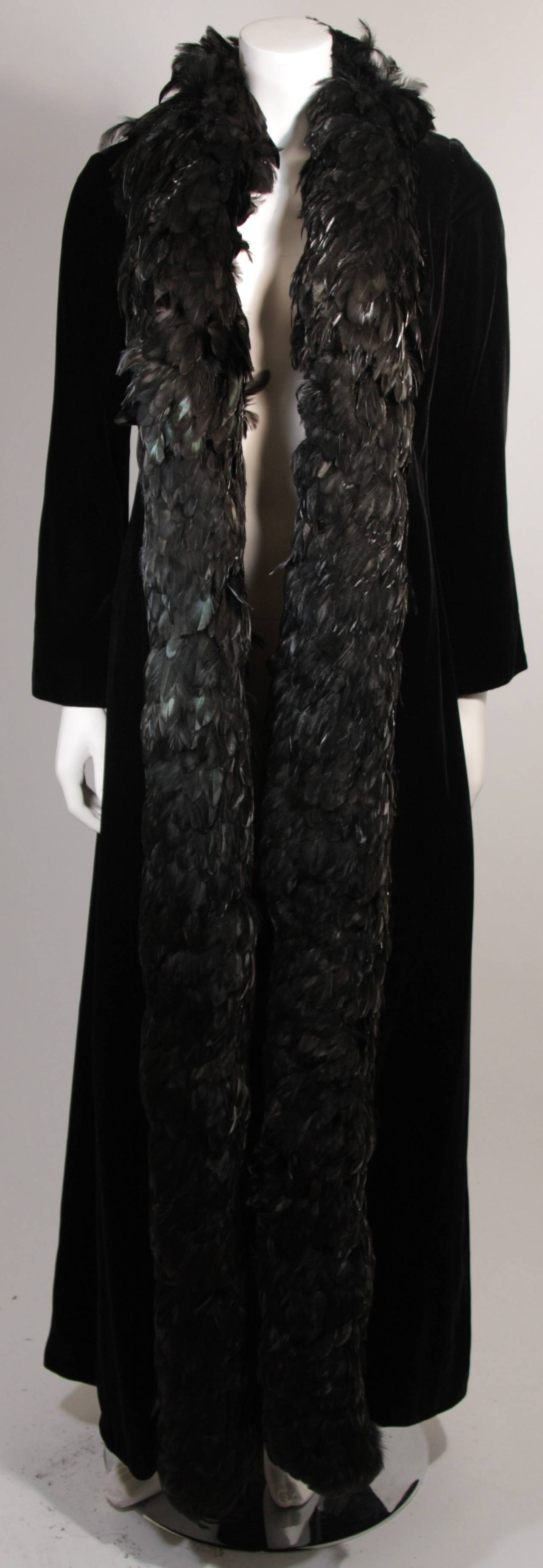 This is a striking black velvet coat trimmed with feathers designed by Victoria Royal of Hong Kong. Superb coat, shows some signs of discoloration throughout in certain lighting, lining is discolored/aged. Great design and style piece. 

Measures