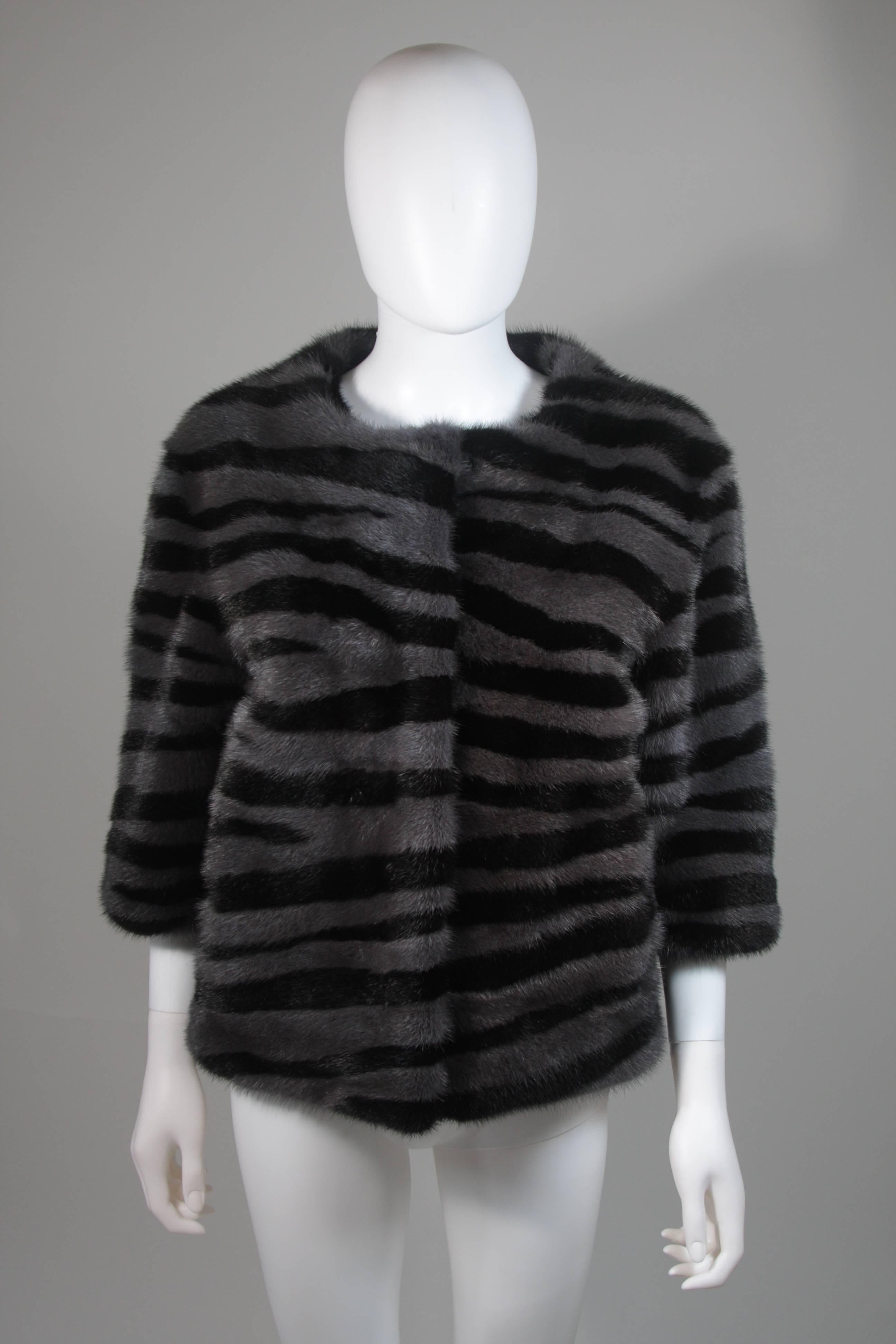 This Marc Jacobs design is available for viewing at our Beverly Hills Boutique. We offer a large selection of evening gowns and luxury garments. 

 This jacket is composed of mink in black and grey with striped patterning. There are center front
