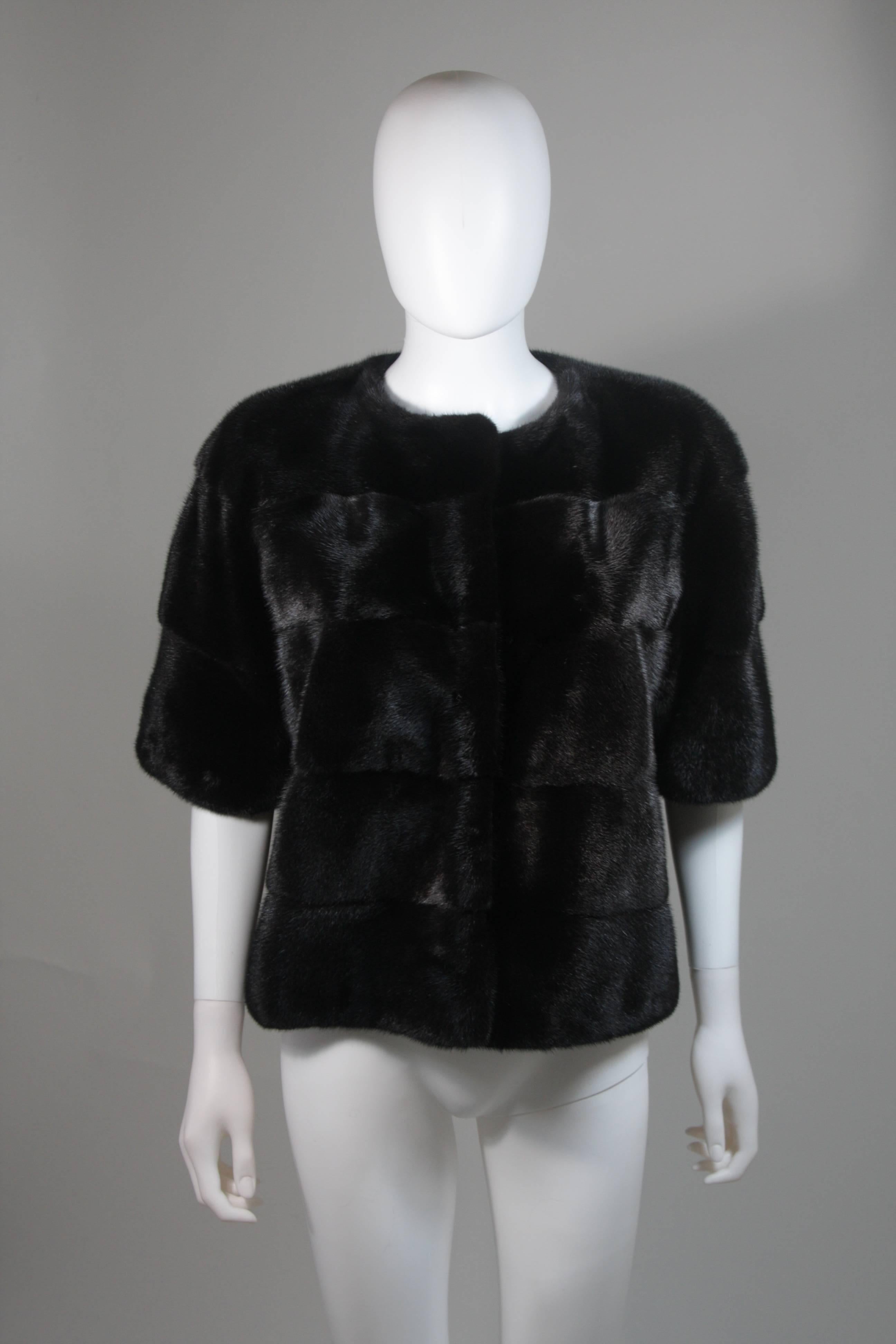  This mink jacket features a dark brown ranch hue with horizontal pelt design. There are center front hook and eye closures. In excellent condition. Made in Denmark. 

  **Please cross-reference measurements for personal accuracy. 

Measurements