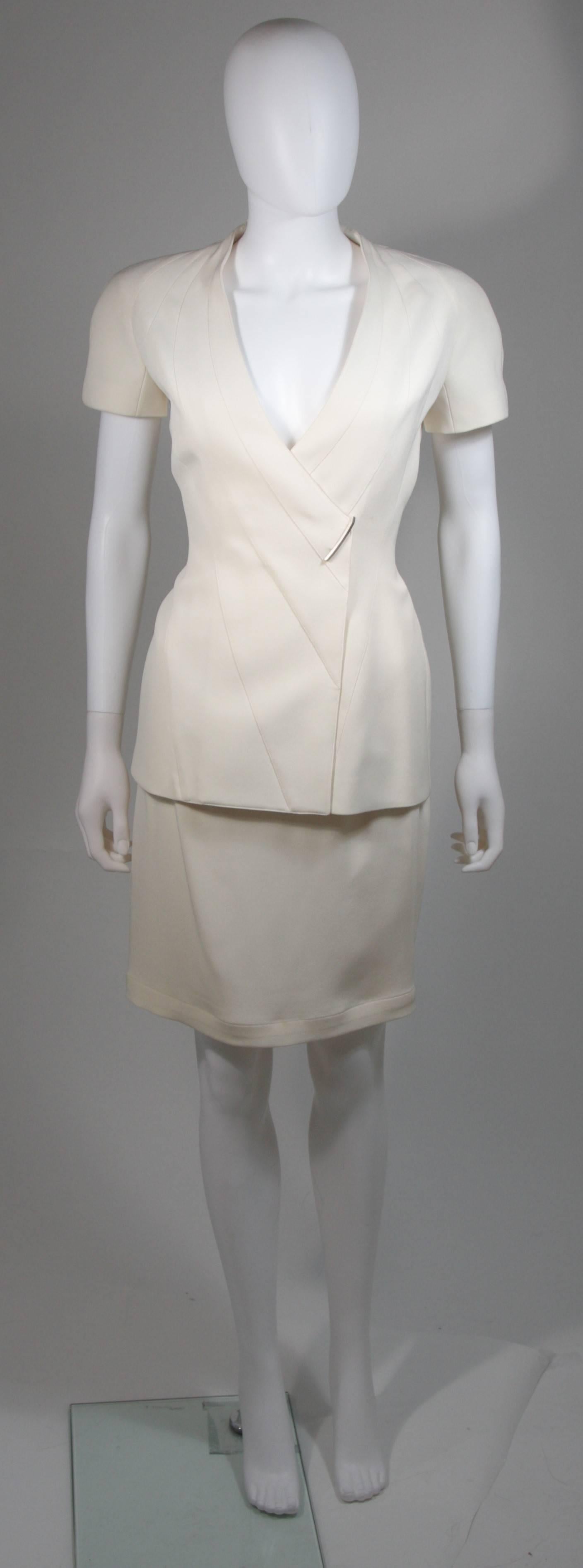 This skirt suit is composed of a white material. The jacket has a center front closures with silver hardware. The skirt has a classic pencil silhouette with zipper closure. In excellent vintage condition. Made in France. 

  **Please cross-reference