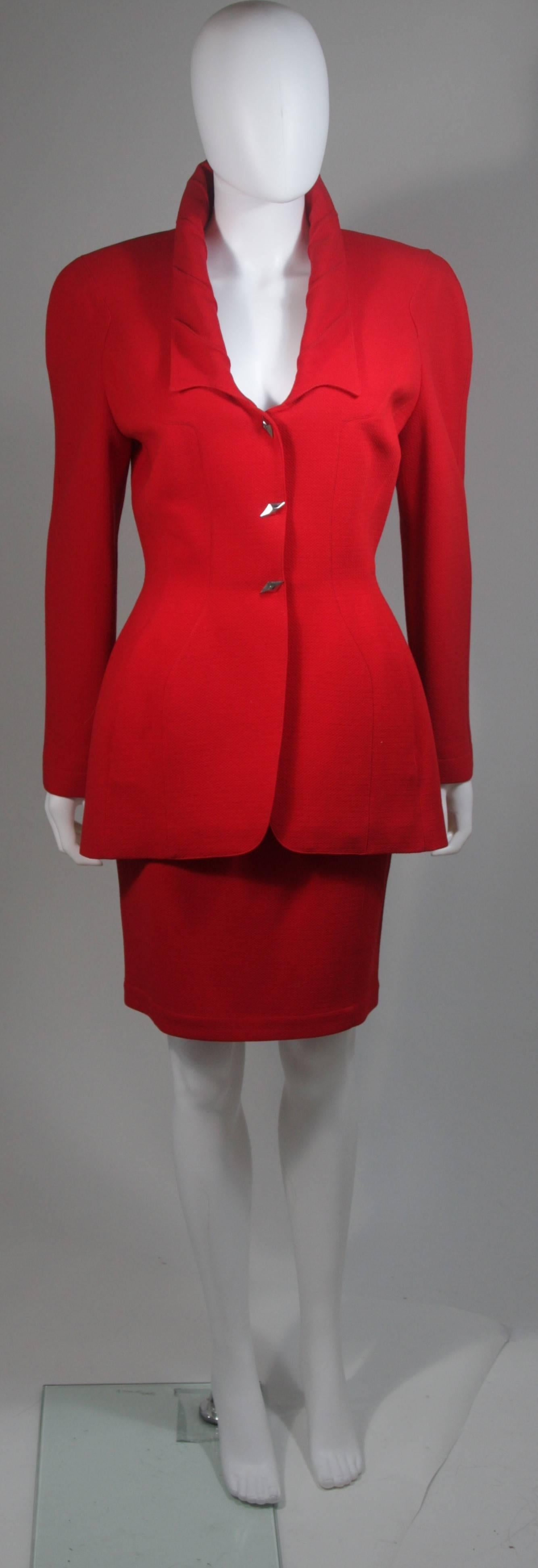  This skirt suit is composed of red fabric. The jacket has center front closures with silver hardware. The skirt has a classic pencil silhouette with zipper closure. In excellent vintage condition. Made in France. 

  **Please cross-reference