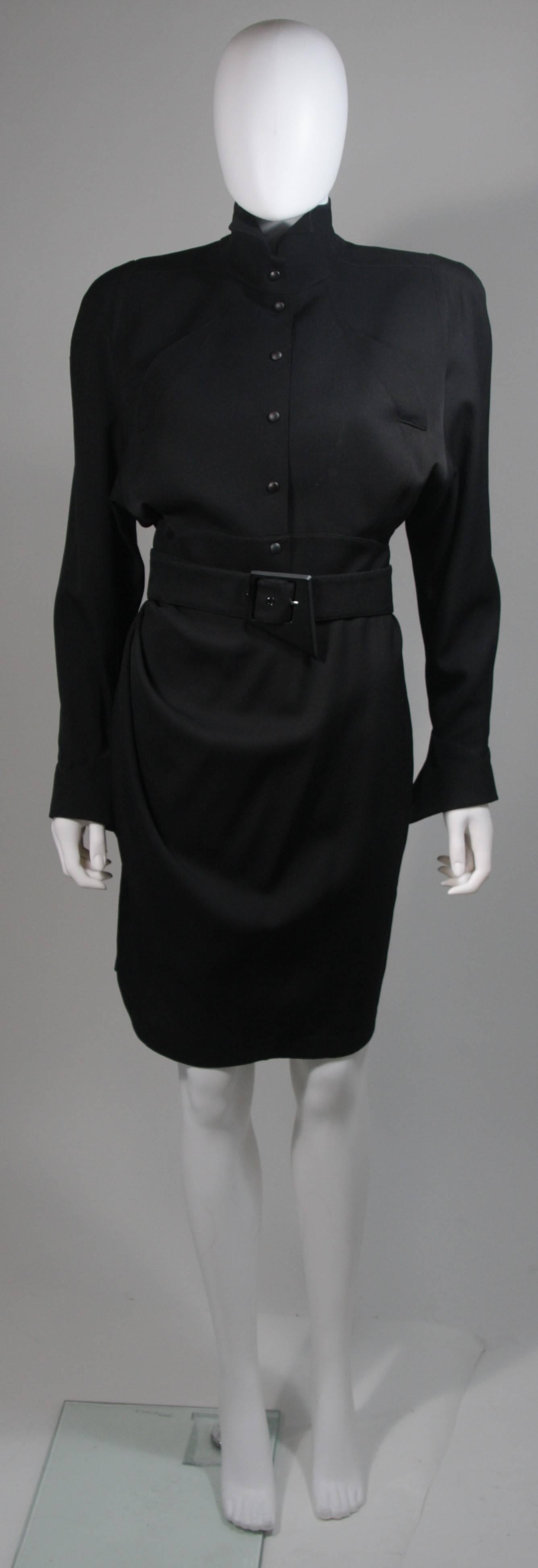  This dress is composed of a black fabric. The dress features a wrap style with belt and center front closures. In excellent vintage condition. Made in France. 

  **Please cross-reference measurements for personal accuracy. Size in description