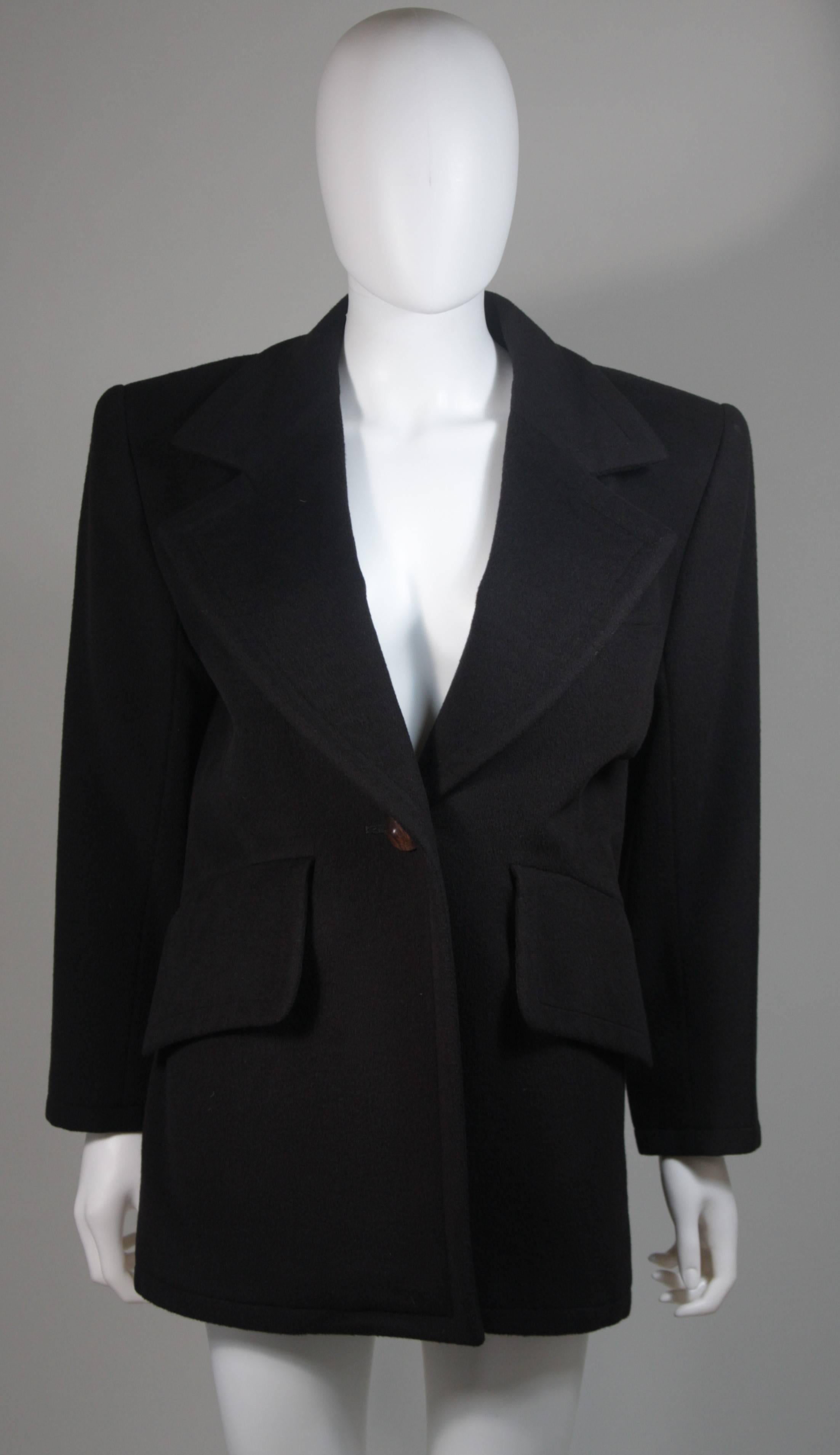  This coat is composed of black cashmere and a silk lining. Features a center front wood button closure and front pockets. In excellent vintage condition. Made in France. 

  **Please cross-reference measurements for personal accuracy. Size in