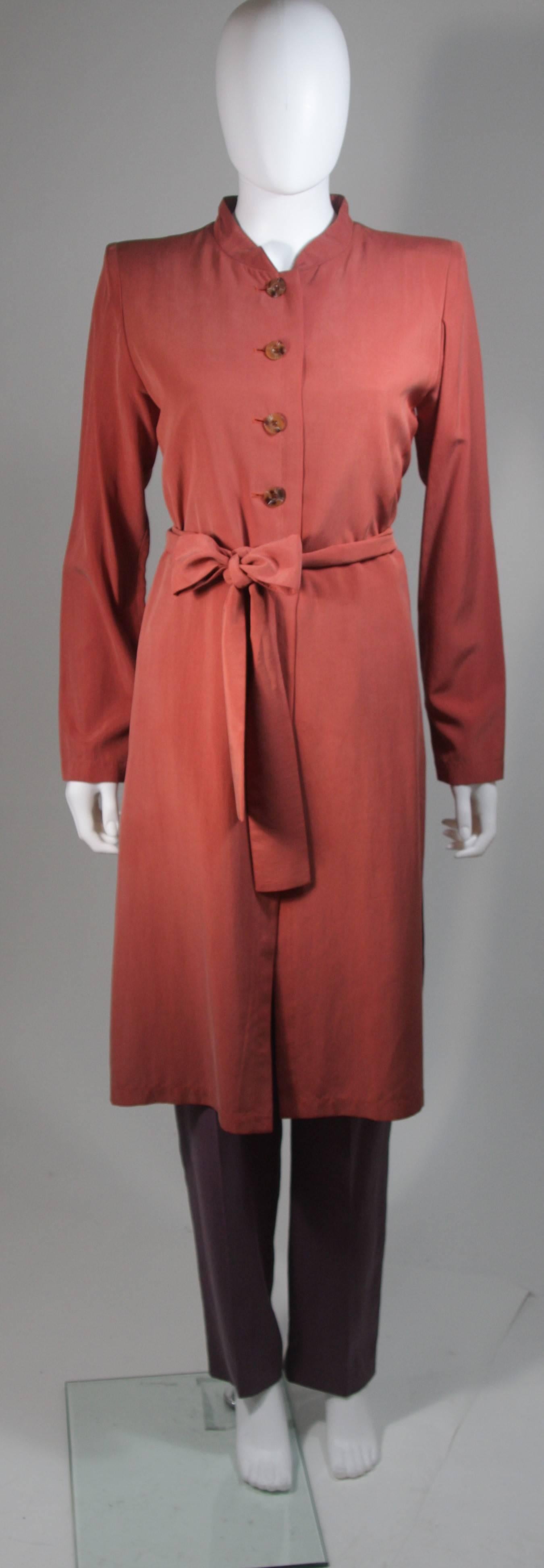  This pant suit is composed of silk. The jacket has a center front closures with side slits. The pants have a classic pleat front silhouette with side zipper closure. In excellent vintage condition. Made in France. 

  **Please cross-reference