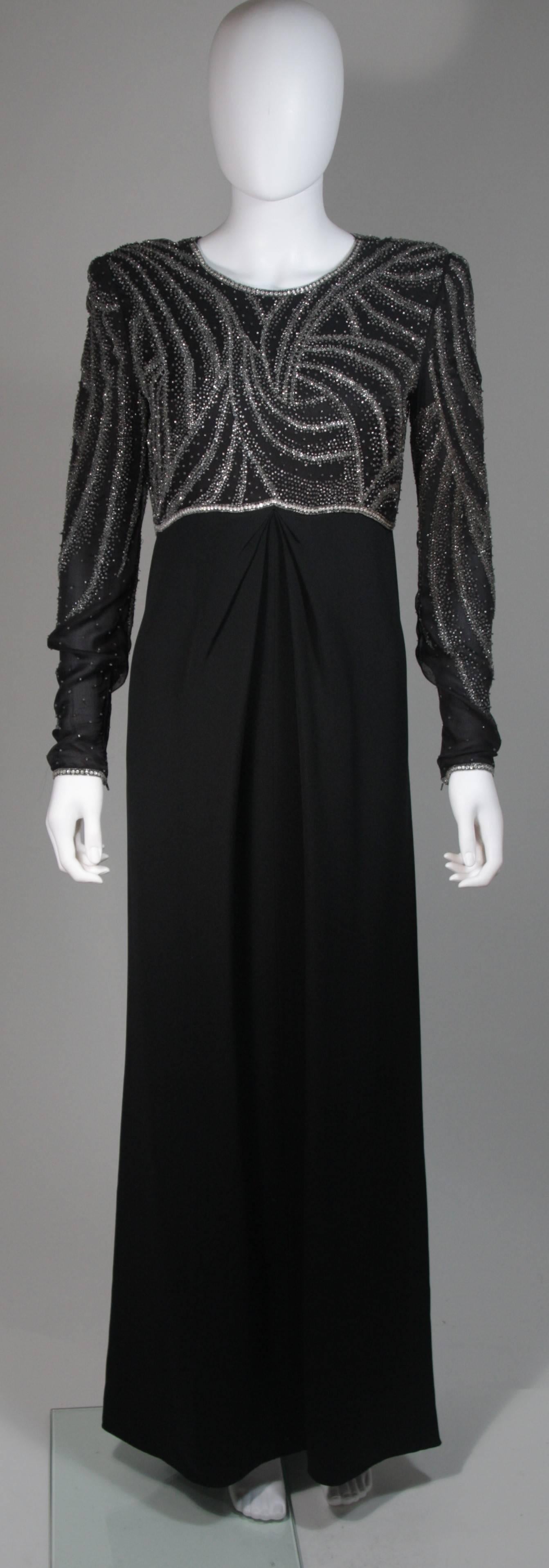 This Bill Blass  gown is composed of a black silk adorned with silver and champagne hued beads on the bodice. Features a center front drape detail, long sleeves, and a center back closure. In excellent condition. Made in USA. 

  **Please