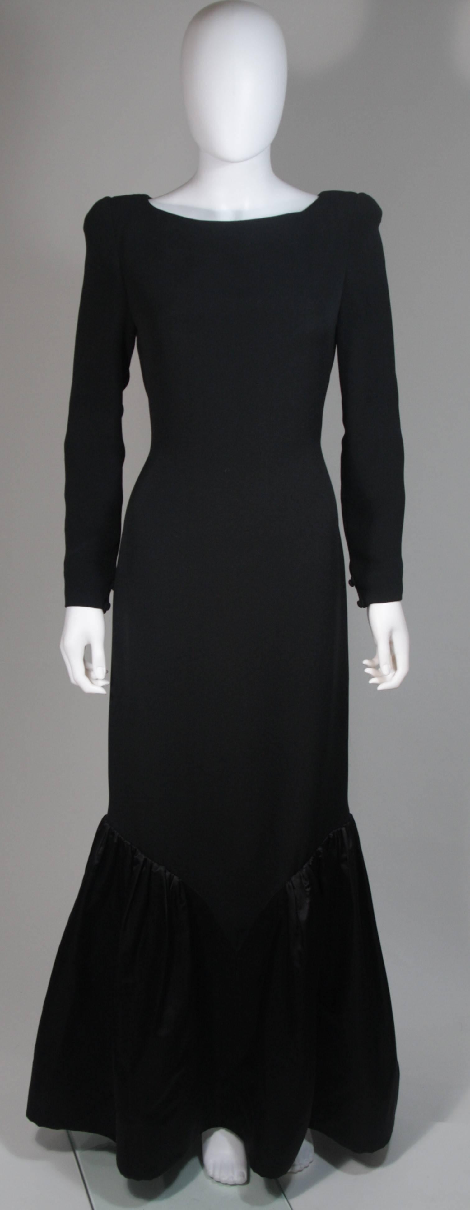 This Bill Blass  gown is composed of a black silk. Features a gathered satin hem detail, long sleeves, and a center back zipper closure. In excellent condition. Made in USA. 

  **Please cross-reference measurements for personal accuracy. The size