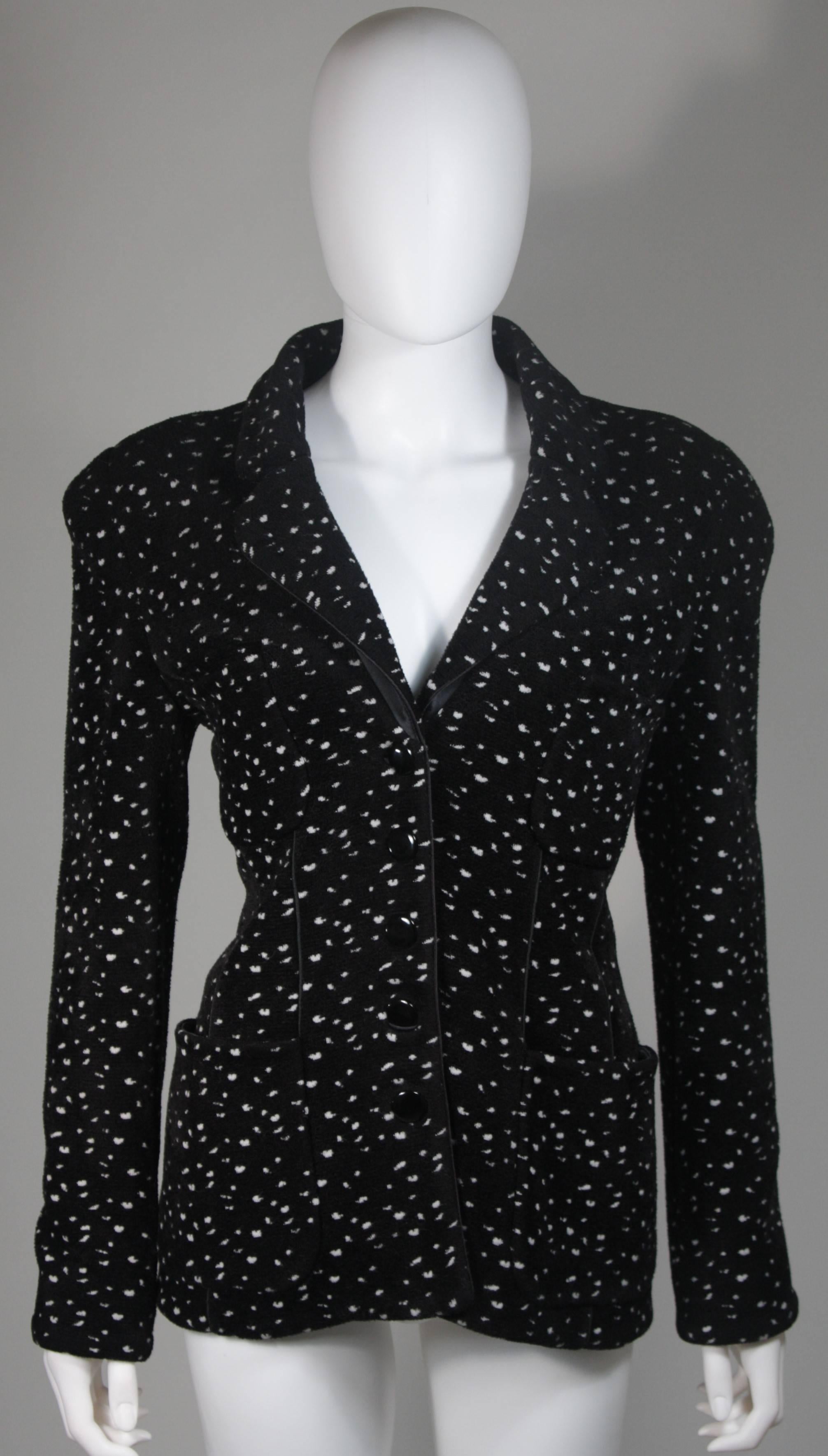 This Giorgio Armani jacket is composed of a wool blend in a black with white speckle textile print. There are front pockets, front button closures, and piping trim. In excellent condition. Made in Italy.

**Please cross-reference measurements for