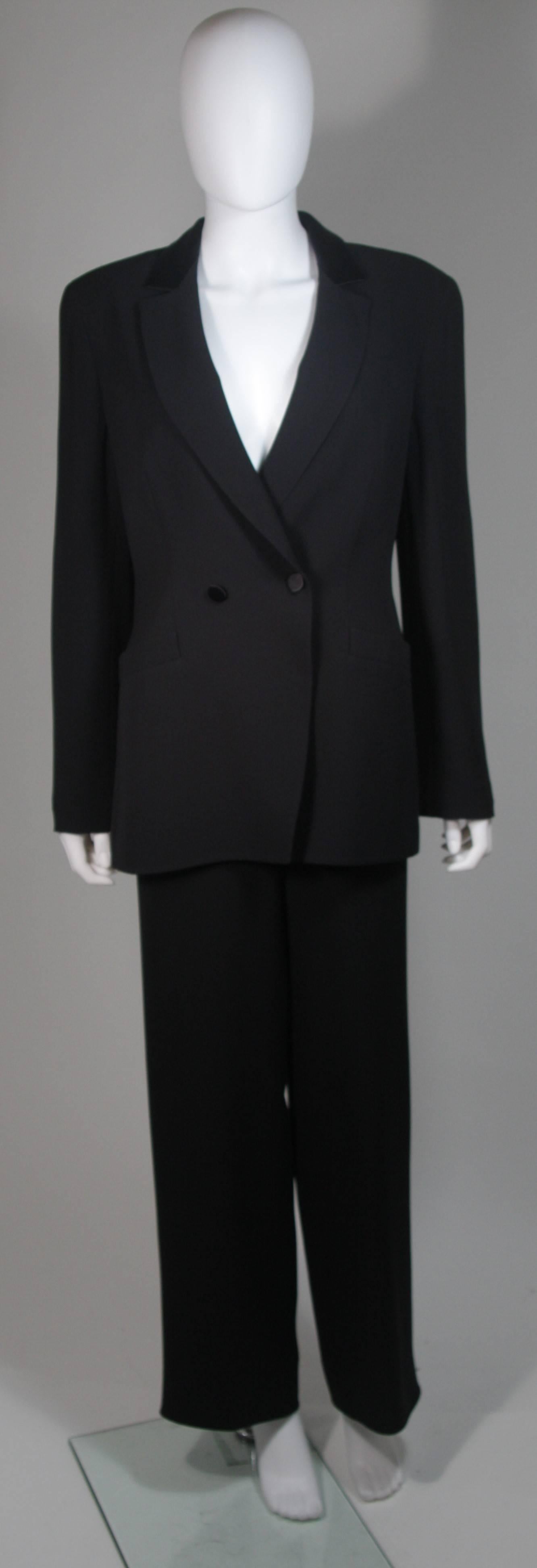 This Giorgio Armani  pant suit is composed of black silk. The jacket features a classic tuxedo style with center front double button detail and silk collar accent. The pants feature a side zip closure. In excellent condition. Made in Italy.

 