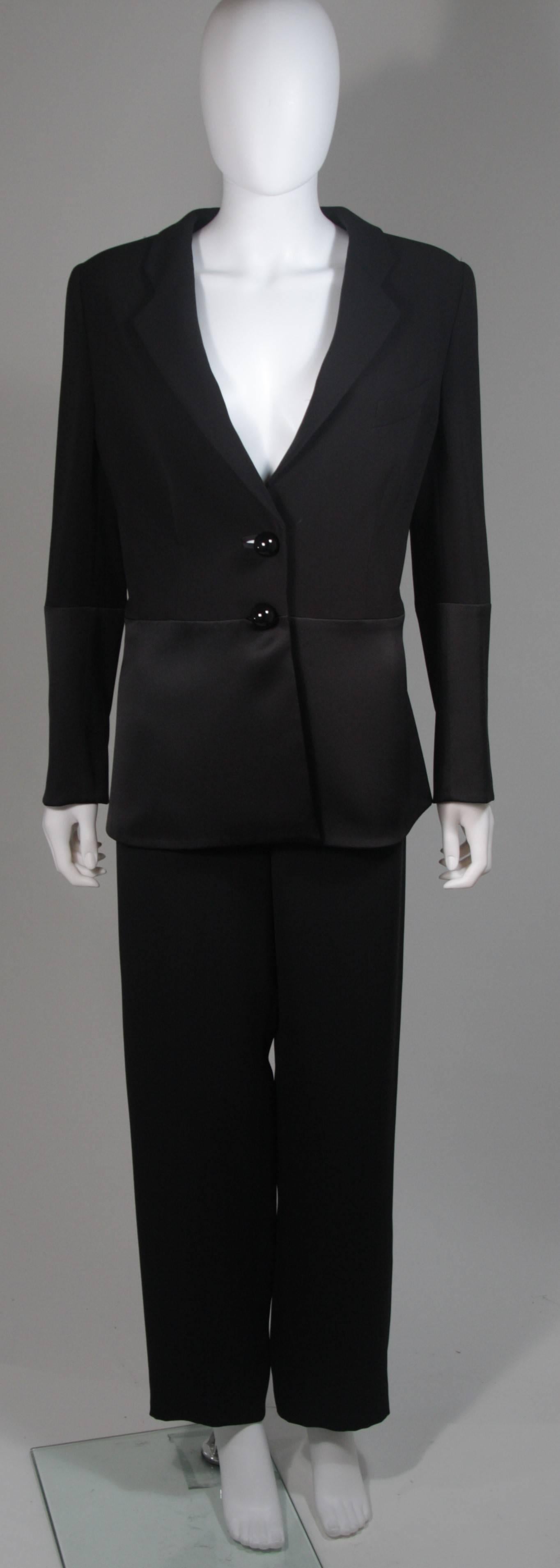 This Giorgio Armani pant suit is composed of a black silk. The jacket features large black buttons and a contrast silk satin detail at the waist. The pants have a side zip closure. In excellent condition. Made in Italy.

  **Please cross-reference