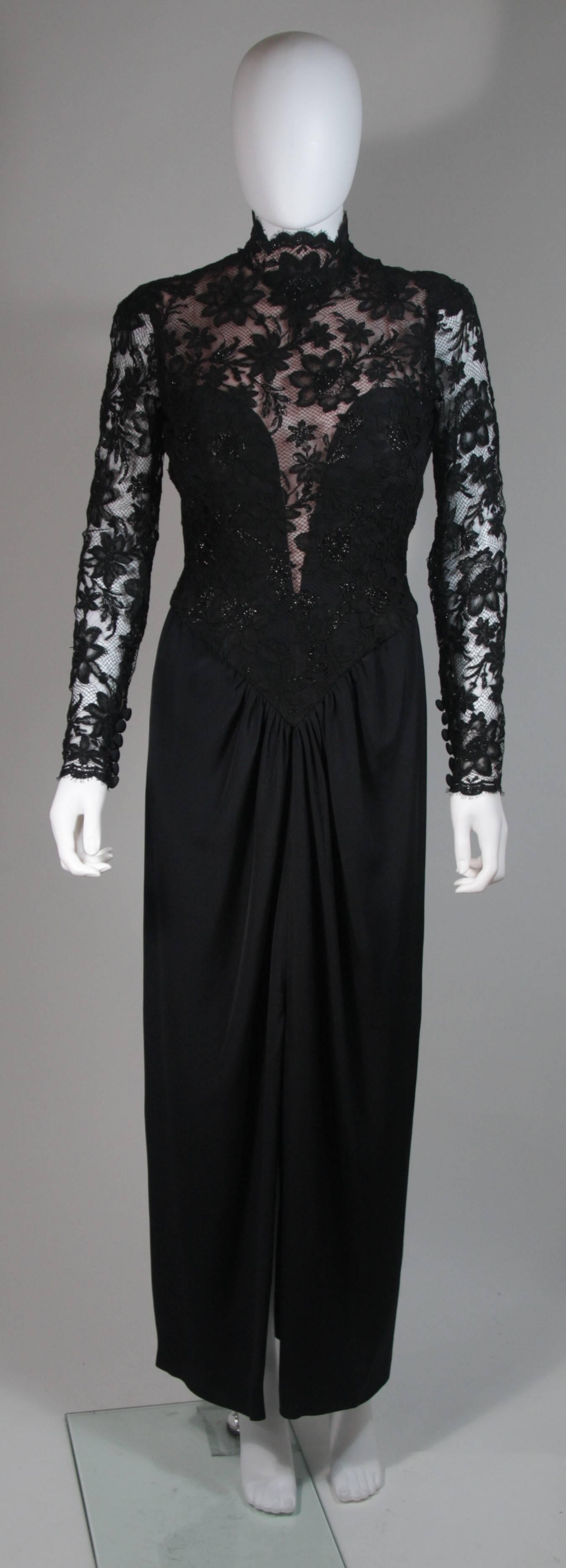 This Bob Mackie design is available for viewing at our Beverly Hills Boutique. We offer a large selection of evening gowns and luxury garments. 

 This gown is composed of black lace and jersey. The lace bodice features a mock neck and scalloped