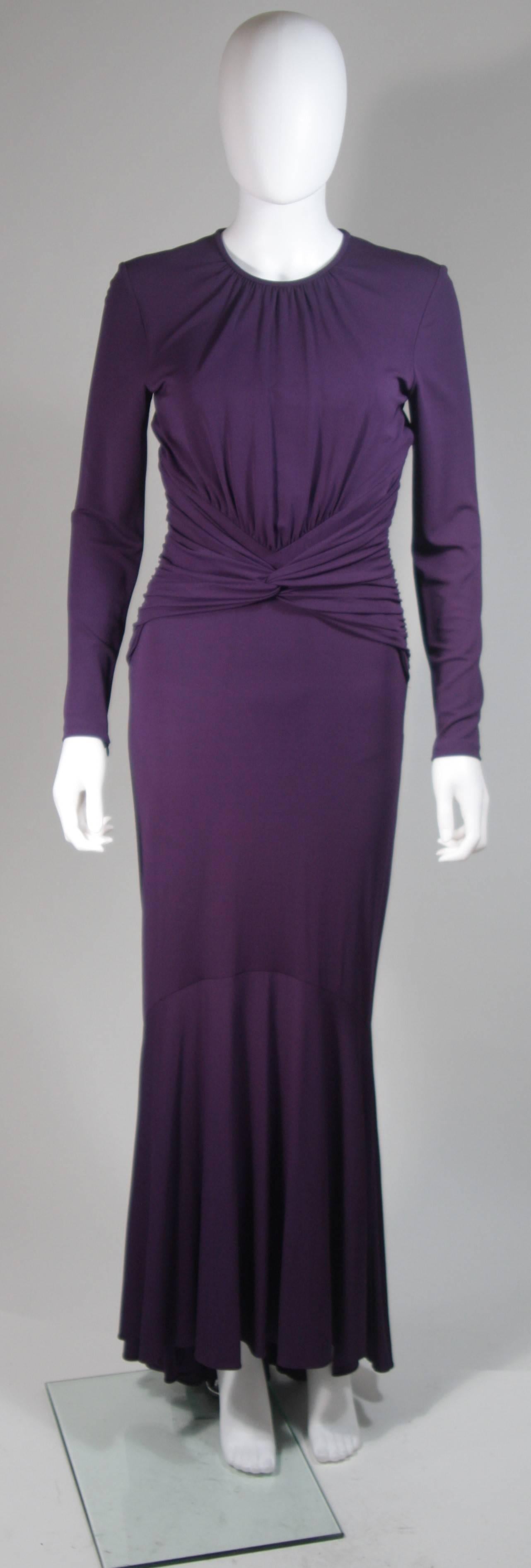 This Michael Kors gown is composed of a radiant soft stretch purple jersey. The classic long sleeve style is modernized with an exquisite open back. There is a top button closure at the center back. In excellent condition. 

  **Please