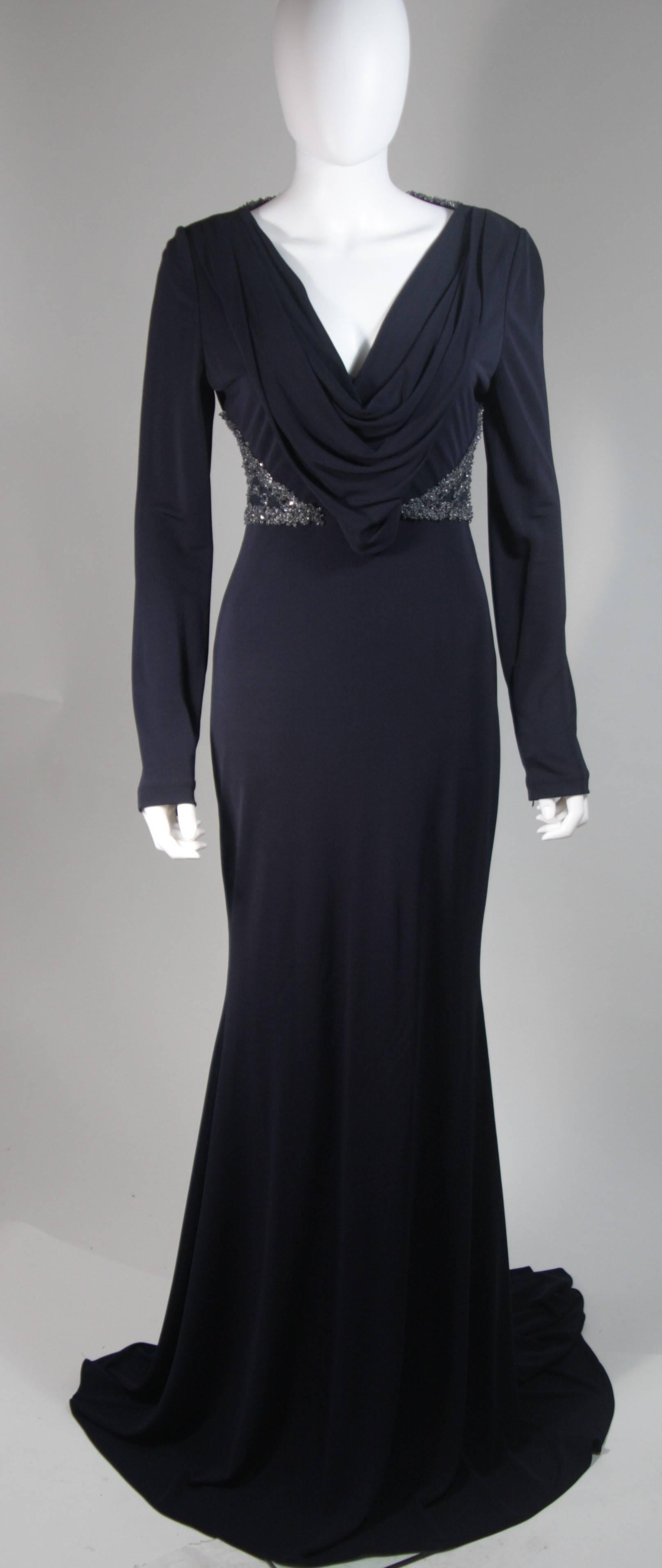 This Badgley Mischka design is available for viewing at our Beverly Hills Boutique. We offer a large selection of evening gowns and luxury garments. 

 This gown is composed of a navy jersey and features side embellishments/beading. The classic